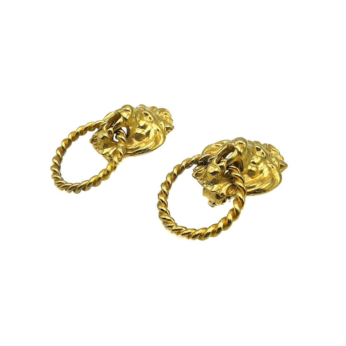 Vintage Lion Knocker Earrings. Featuring a Lion's head with a twisted hoop suspended from the jaw. In gold plated metal. 5cms. High quality. In very good vintage condition. Most likely French. Such a supremely stylish statement earring you can