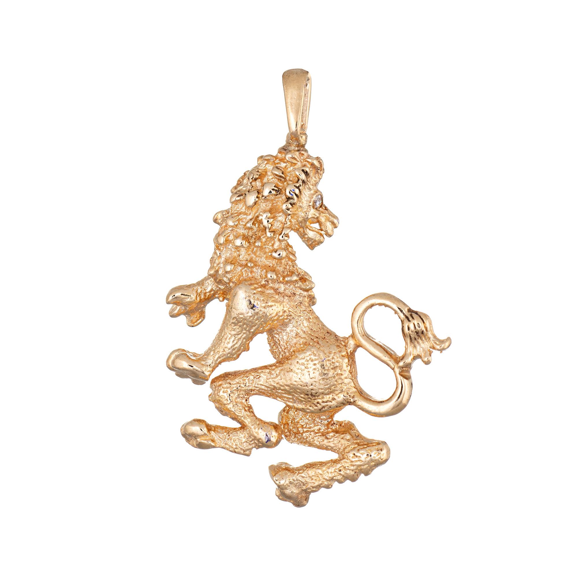 Finely detailed vintage Lion pendant (or charm) crafted in 14k yellow gold.  

One estimated 0.01 carat single cut diamonds is set into the eye (estimated at H-I color and VS2 clarity).

The nicely detailed pendant features a Lion in standing pose