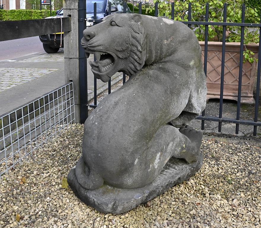 Vintage lion statue made out of old stone.