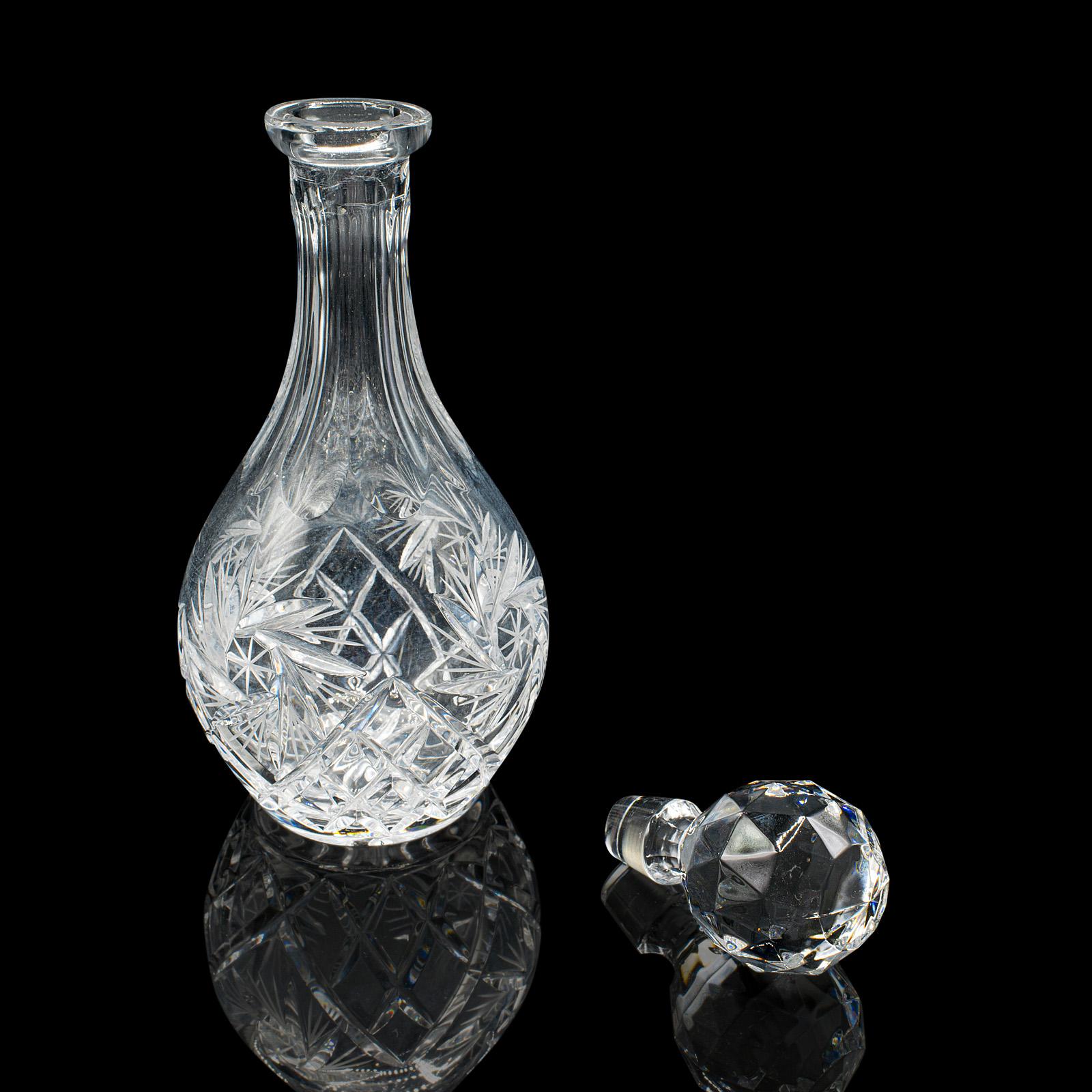 This is a vintage liqueur decanter. An English, cut crystal glass Sherry or wine vessel, dating to the mid 20th century, circa 1960. Elegantly crafted and richly detailed, ideal for refined drinks service.

Tall bulb-shaped body with excellent