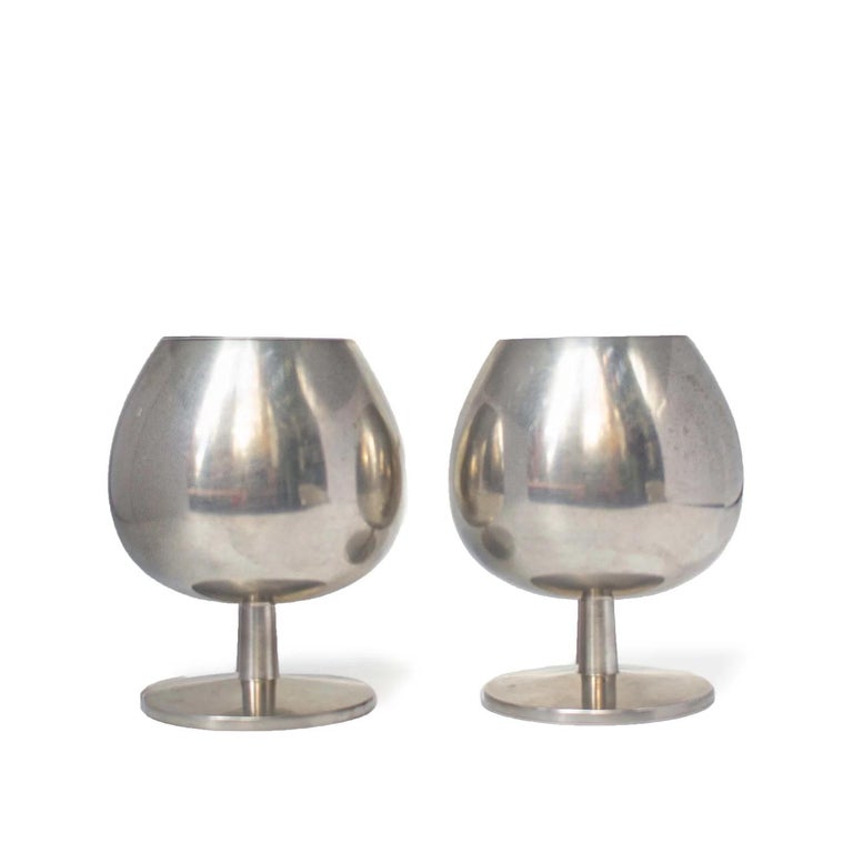 Liquour Goblets by Metawa Holland.

Made in the Netherlands.
Material: silverplate metal.
1960s.
Measures: 3 x 3.5 in / each.


Set of two metal cognac glasses. These goblets with a short stem and balloon rounded cup make the perfect glass