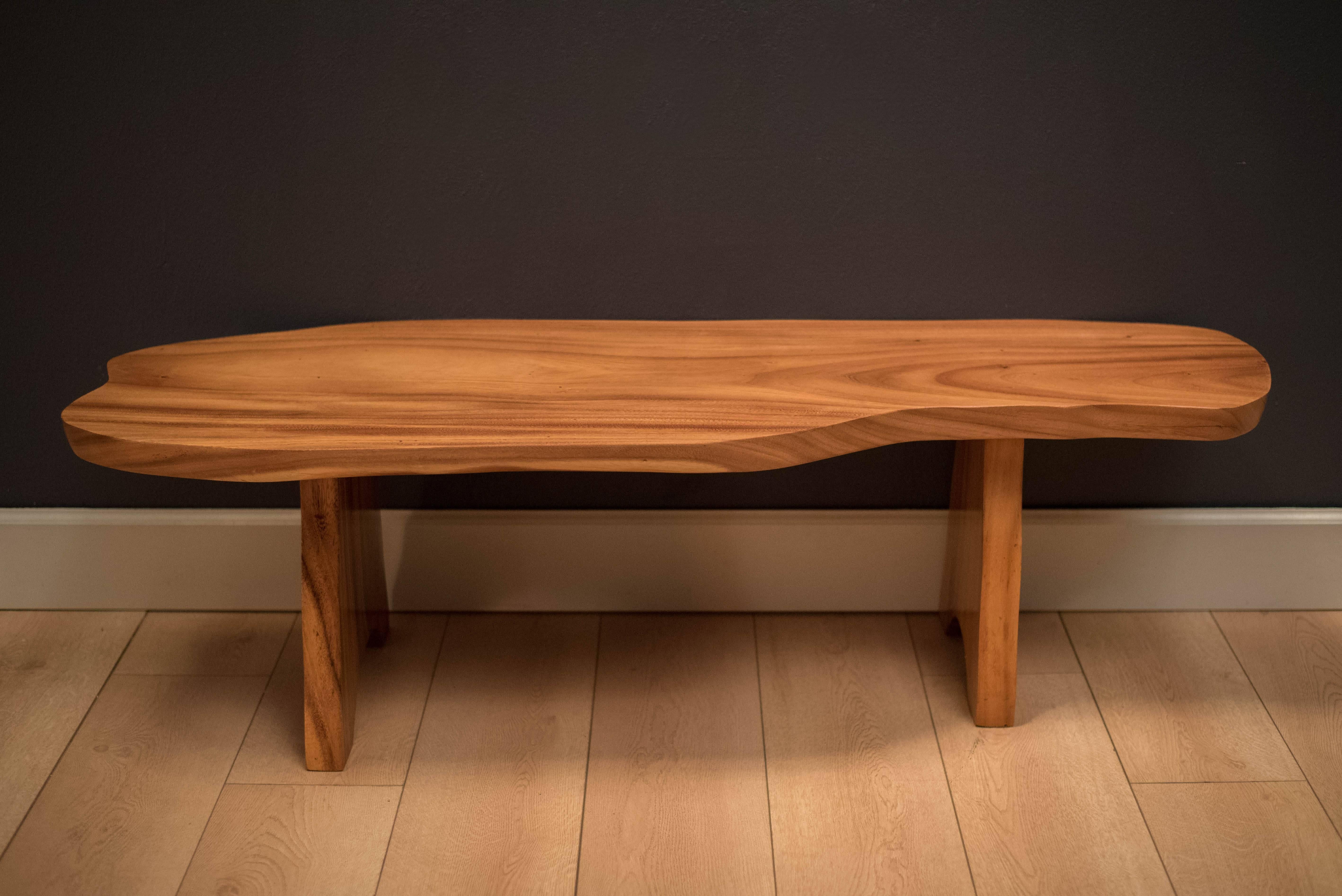 Mid Century free-form solid monkey pod table from the 1960s. This versatile piece is sturdy enough to use as a custom bench or coffee table.