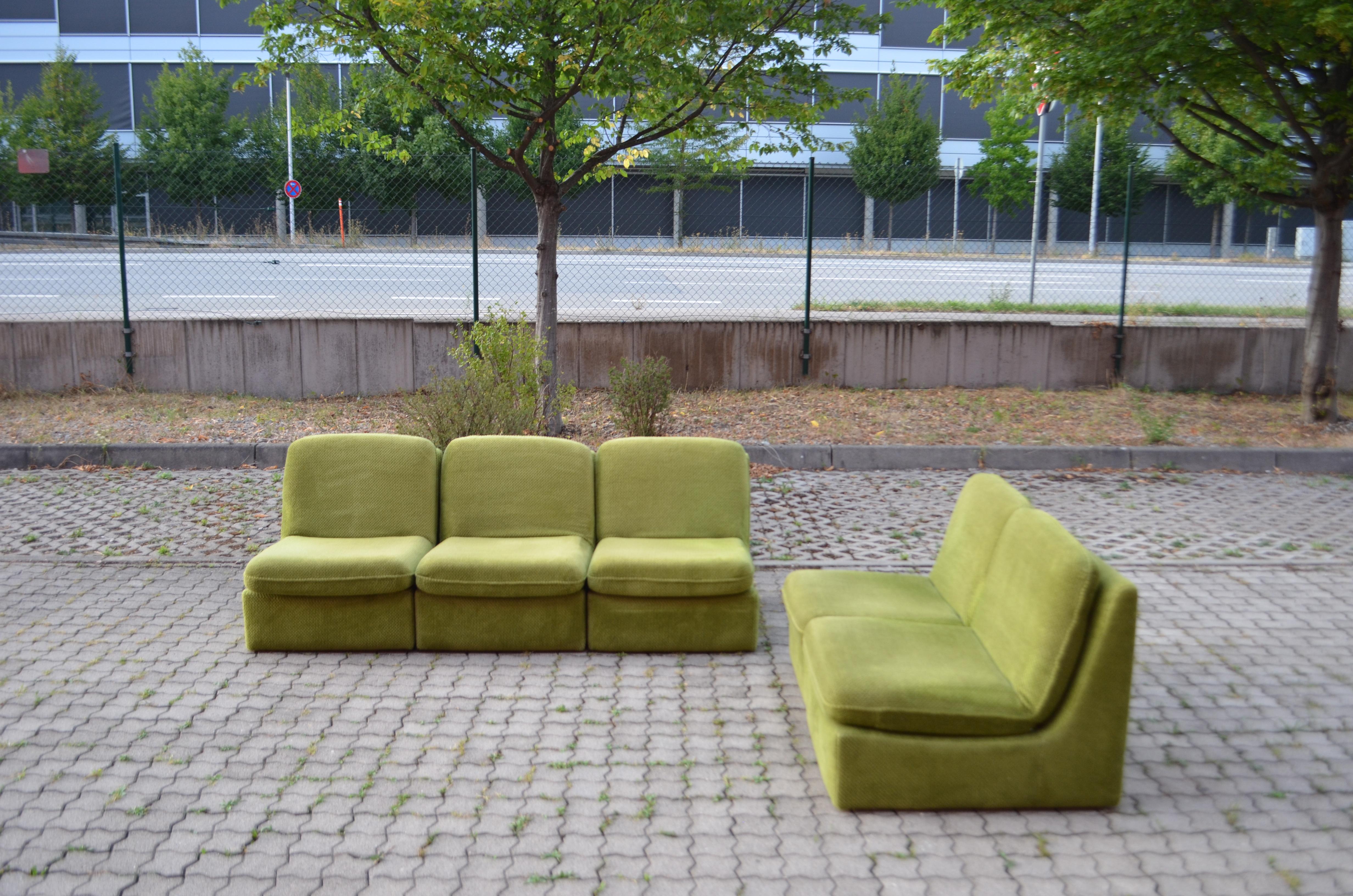 This Modular sectional sofa was manufactured in Germany.
It is a pure 70ties design with timeless modern shape.
The fabric is a limegreen velour and has a beautiful soft touch.
The frame of every element is made of wood and upholstery in the