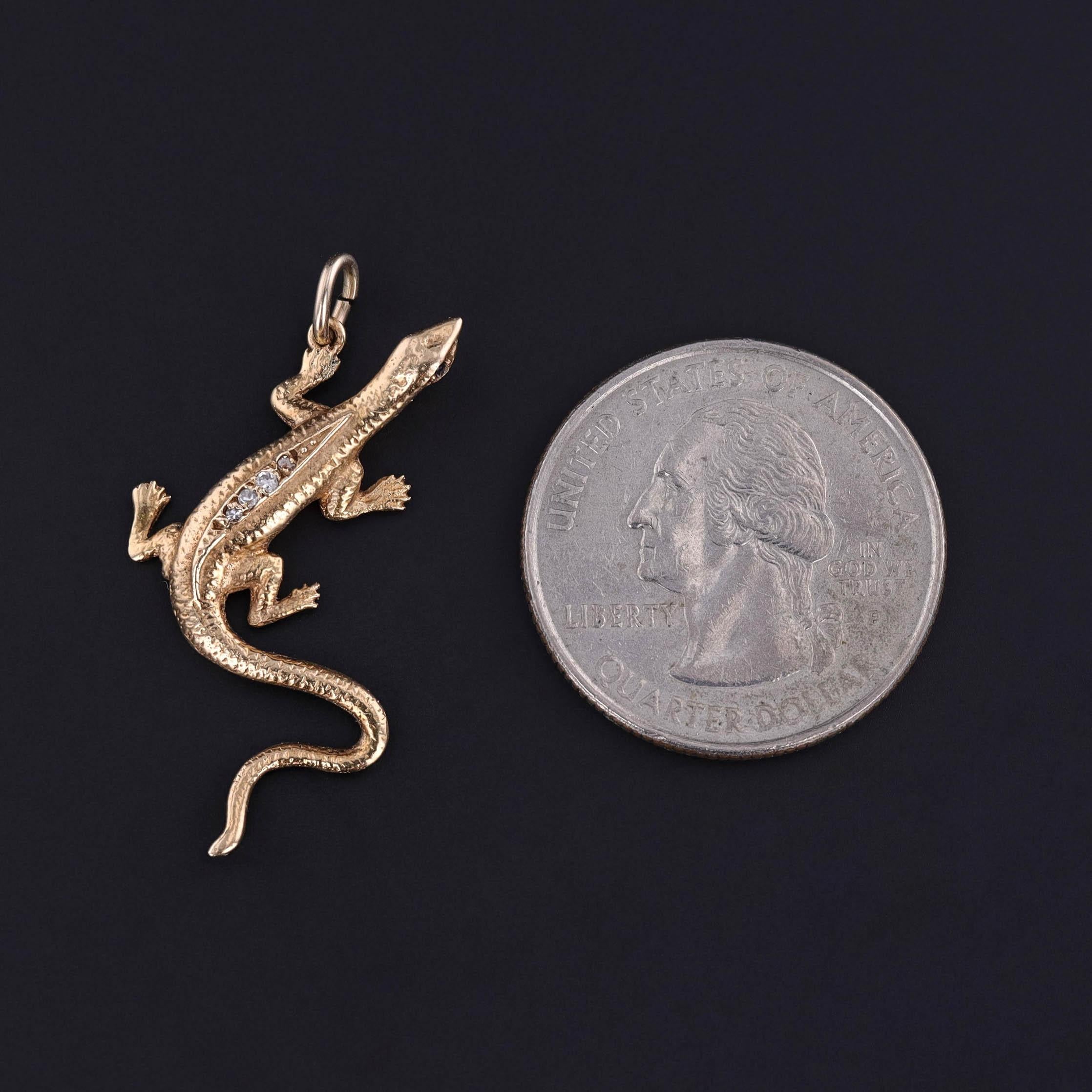 This fun pendant features a 14k gold lizard with sapphire eyes and sparkling diamond accents.

The pendant is unmarked, but acid tests for 14k gold. It was originally a vintage brooch (circa 1950) transformed with the addition of a gold jump ring