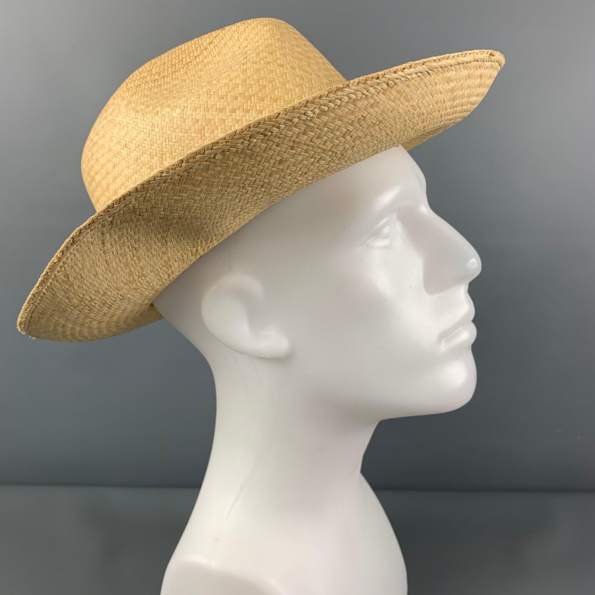 Vintage LOCK & CO HATTERS hat comes in a beige straw material featuring a ribbon trim. Made in England.
Very Good
Pre-Owned Condition. 

Marked:   57/7 

Measurements: 
  Opening: 21.5 inches  Brim: 3.25 inches  Height: 4 inches 
  
  
 
Reference: