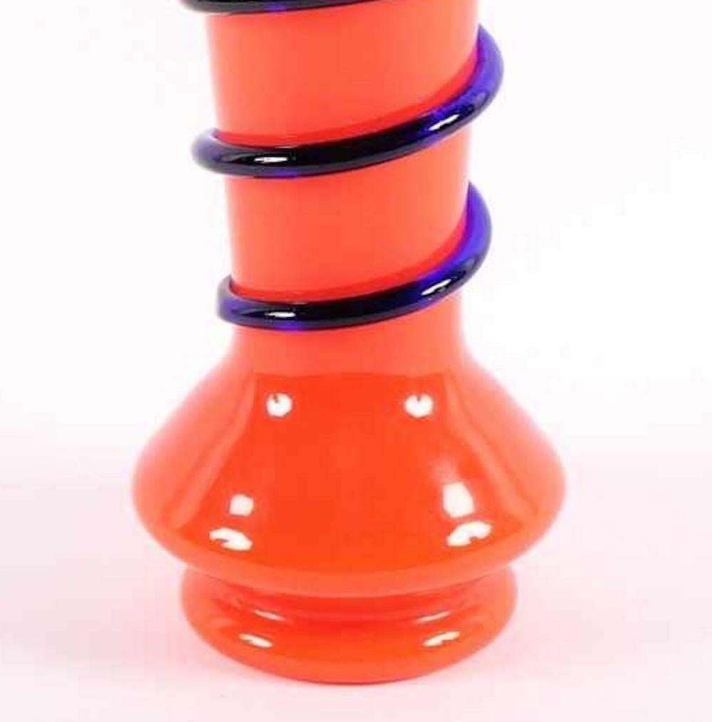 This Tango vase is an original decorative object realized in the 20th century, in the circa 1920s.

Beautiful cylindric orange-colored vase with a cobalt blue decoration.

Realized by Loetz, the premier Bohemian art glass manufacturer during the