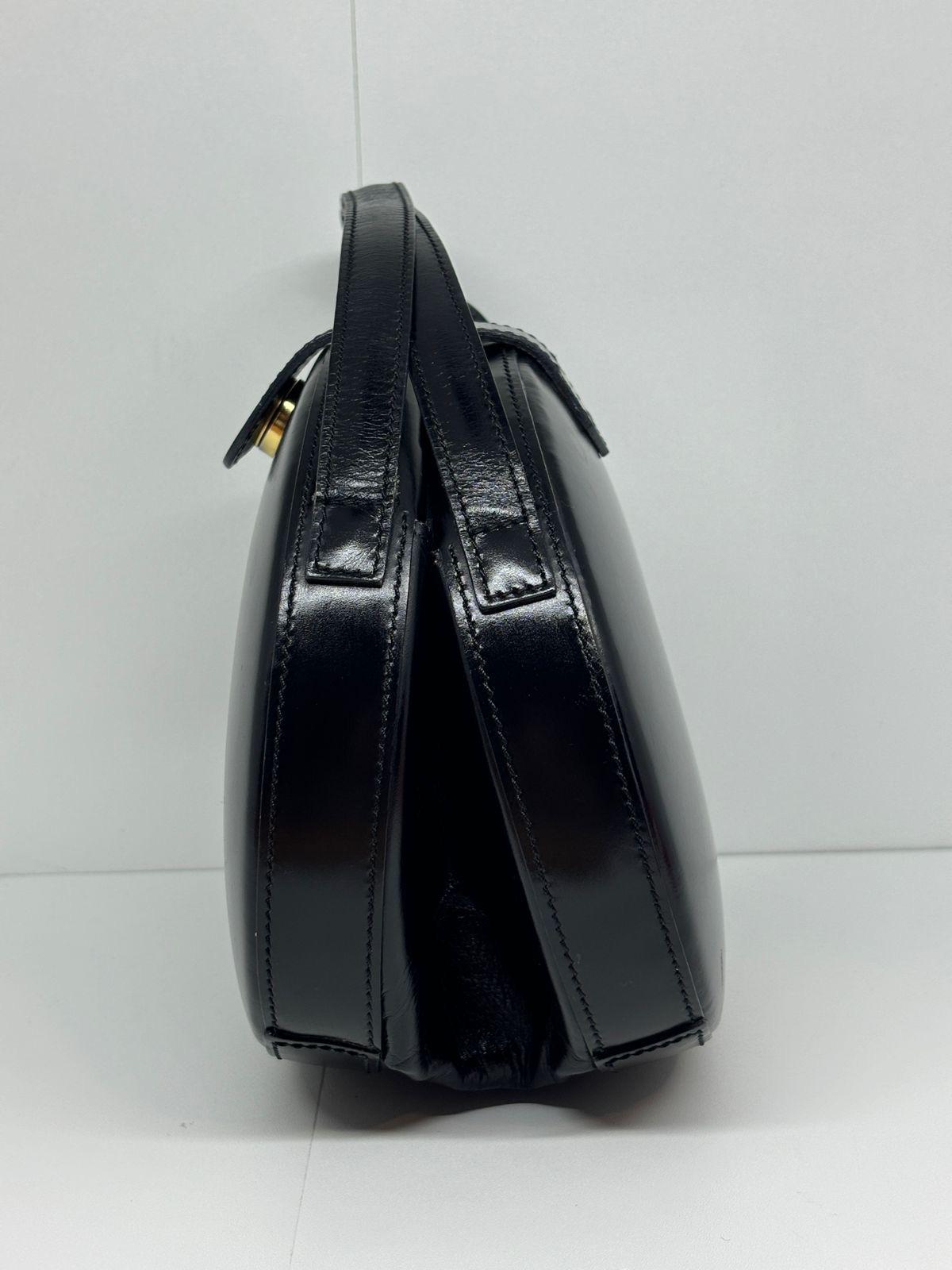 Beautiful vintage loewe round bag in box like black leather. Very good vintage condition, with visible light creasing and scuffing. Comes with its original booklet and dust bag.