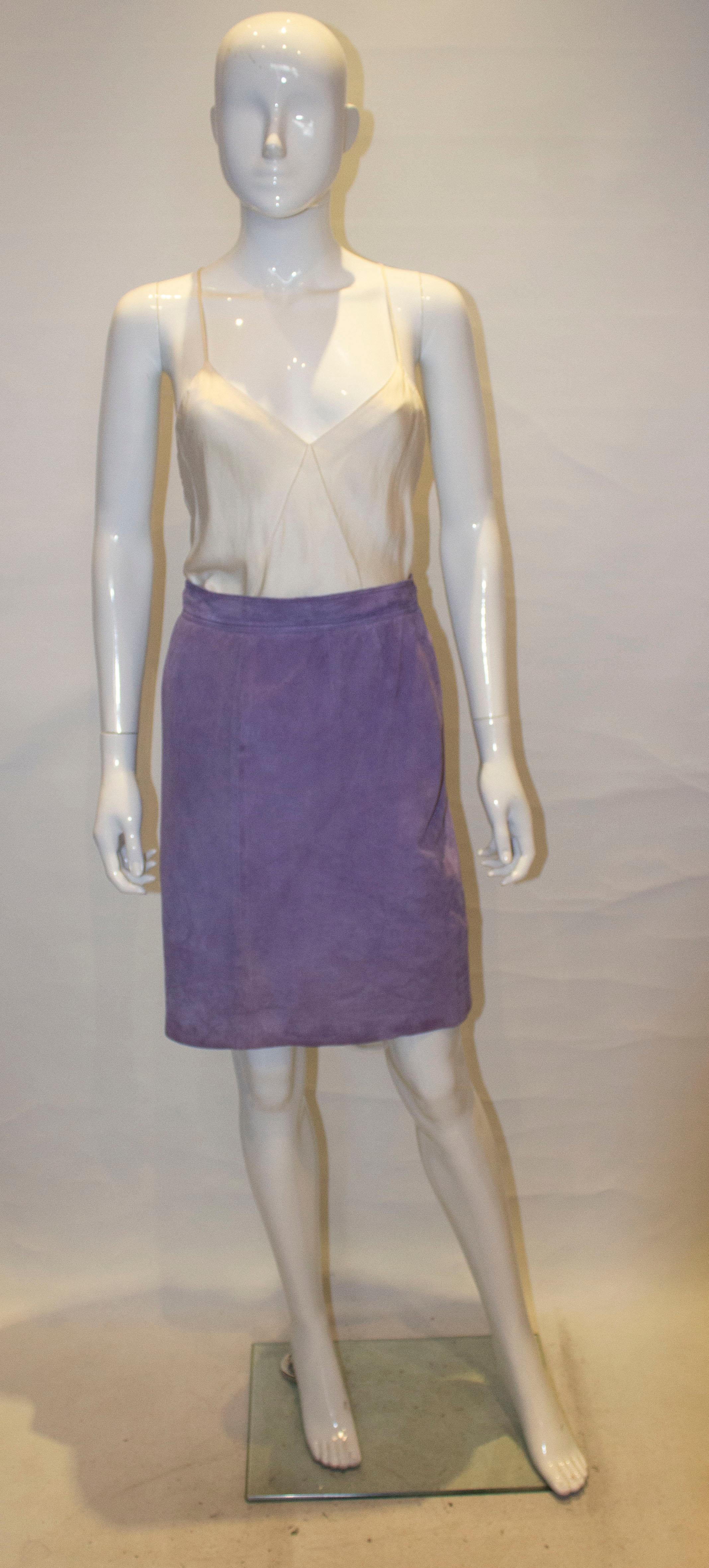A super soft vintage suede skirt by Spanish brand Loewe. In a pretty lilac shade, the skirt has a 
central back zip and is fully lined. 
