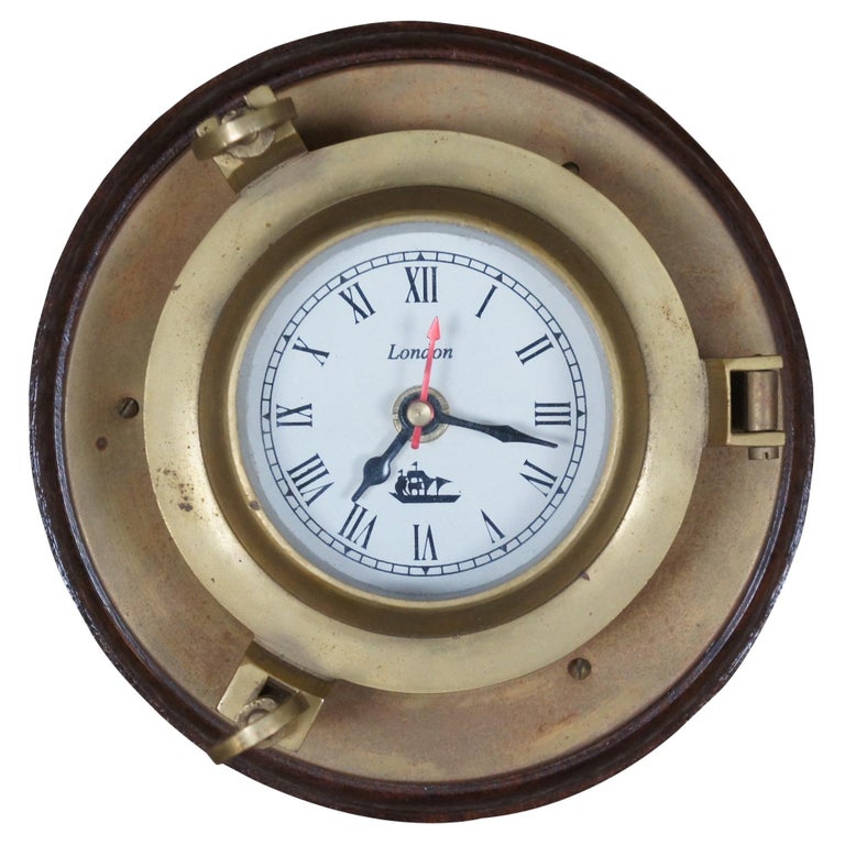 A mid-20th Century brass cased ships clock, the circular painted dial with  Roman numerals and slow/f