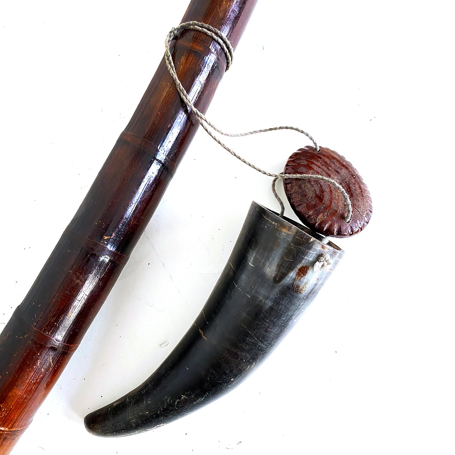 Vintage long bamboo pipe with horn tobacco container, Chinese, 20th century.

Very long black bamboo pole fashioned into a pipe with the root constructed into a bowl covered with brass and copper held on with steel knobs. Accompanied by a horn