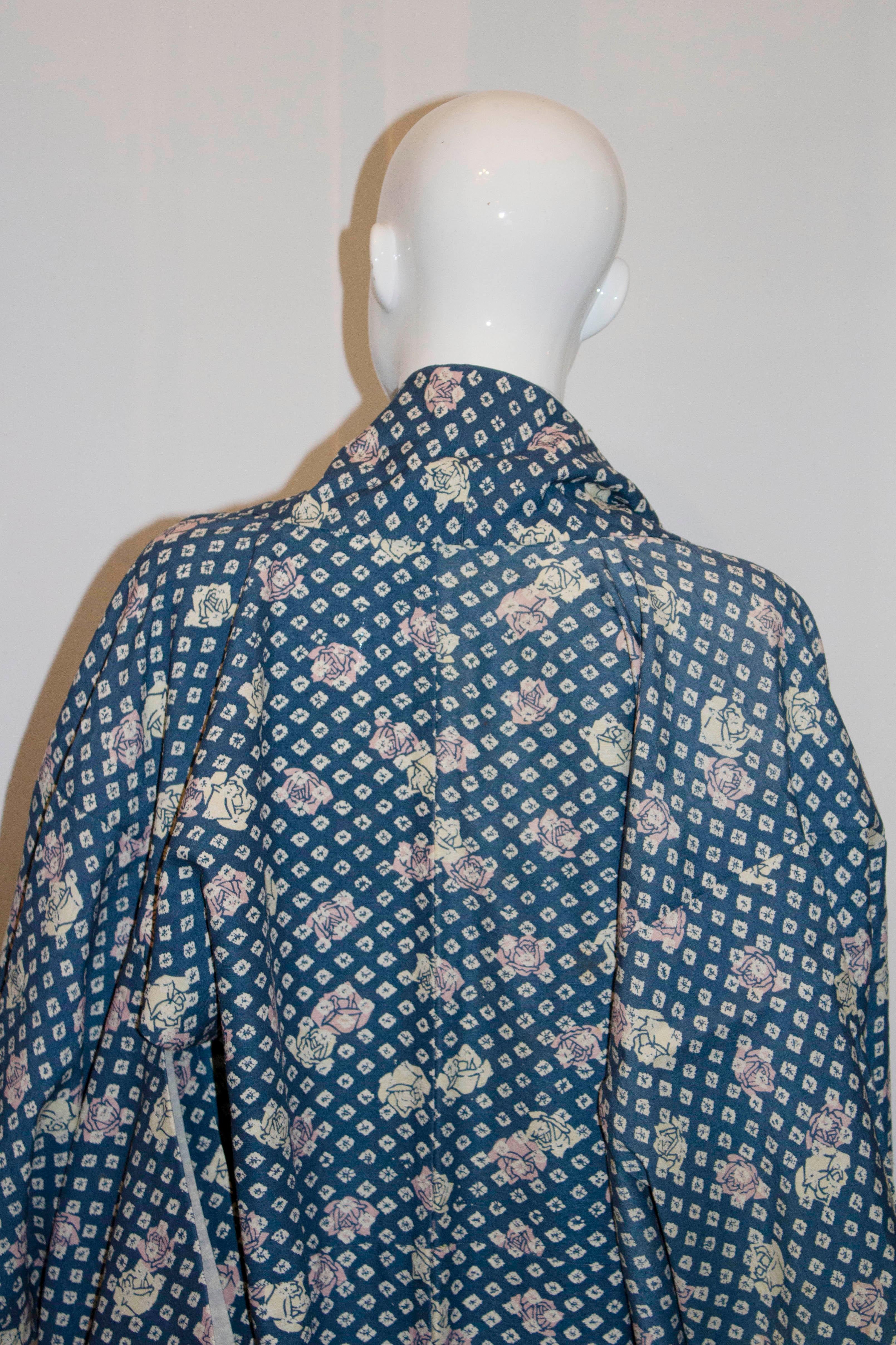 A vintage kimono from Kyoto dating from the 1980s. It has flowers on a blue background and is lined in cotton.
Measurements: Length 63'' bust up to 46''