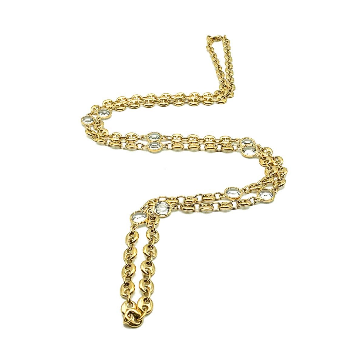 A very long Vintage Crystal Mariner Chain. Featuring mariner link chain interspersed with bezel set crystal stones.  
Vintage Condition: Very good without damage or noteworthy wear. 
Materials: gold plated metal, glass crystal
Signed: unsigned