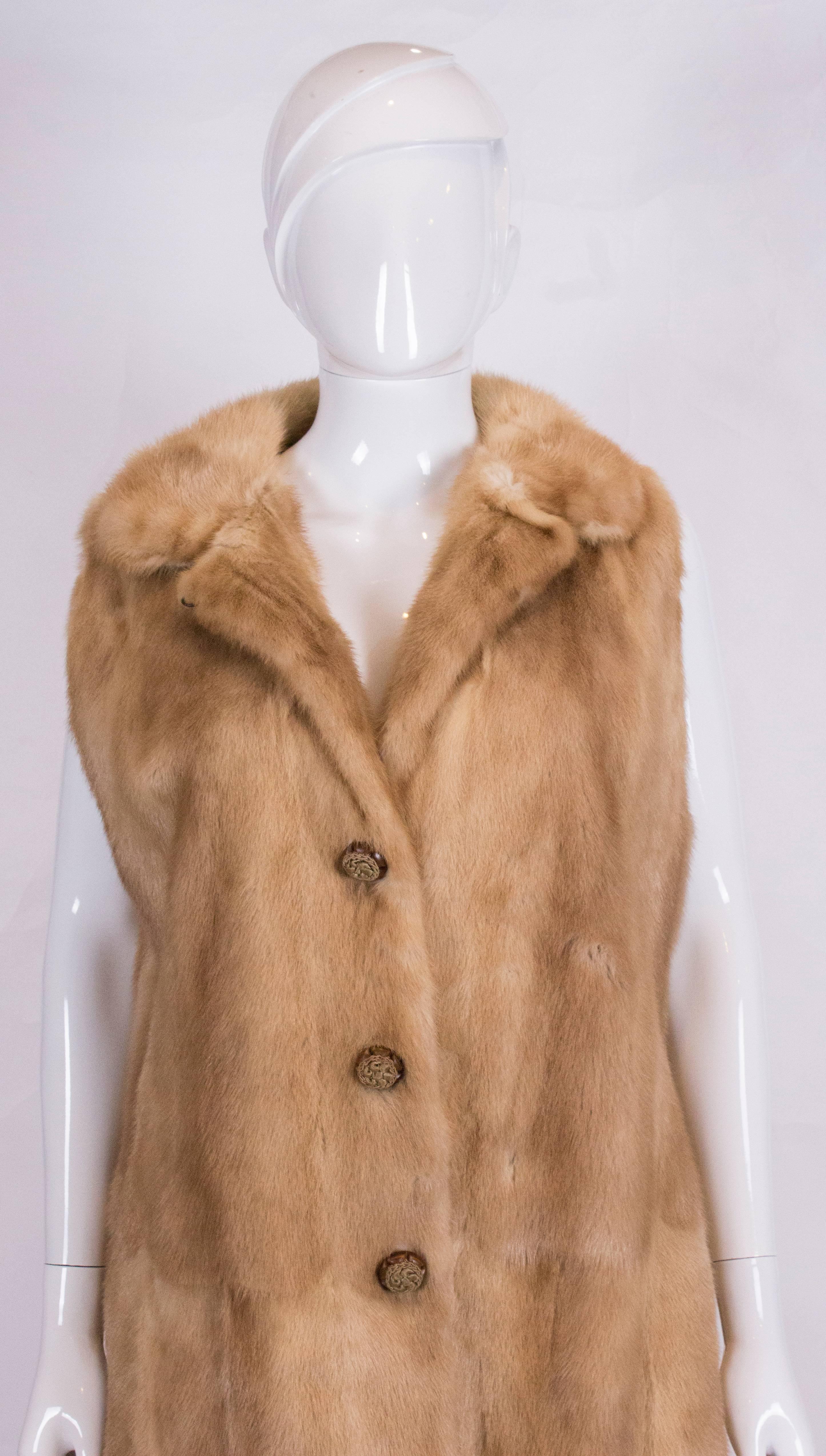 A great vintage  mink gilet, ideal for Fall/Winter. The gilet is a honey coloured mink, with a 3 button opening, and pockets on either side.