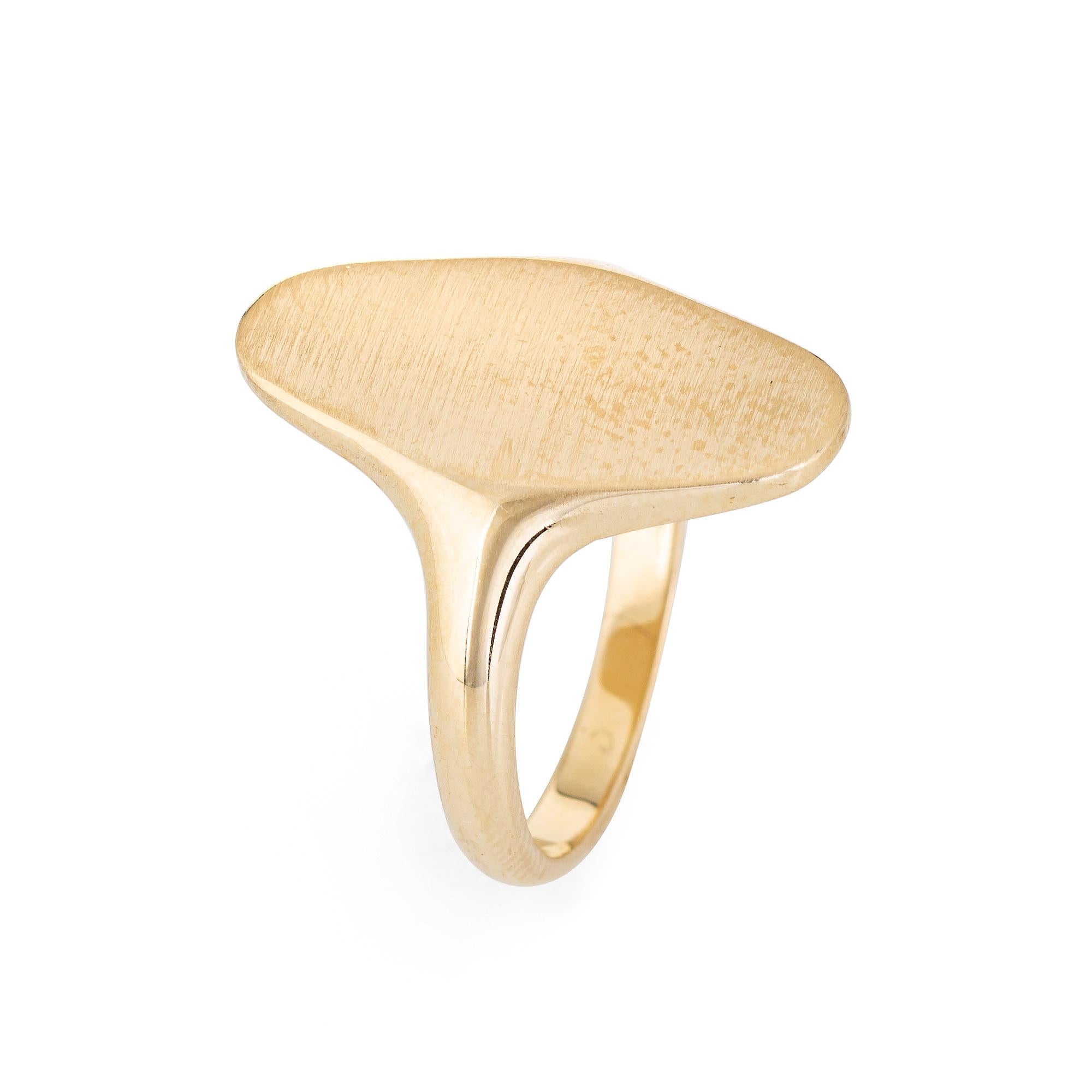 Stylish vintage oval signet ring crafted in 14 karat yellow gold. 

The long oval signet mount is currently unadorned and can be customized if desired. The ring sits flat and comfortably on the finger (rising 1.5mm - 0.05 inches).  

The ring is in
