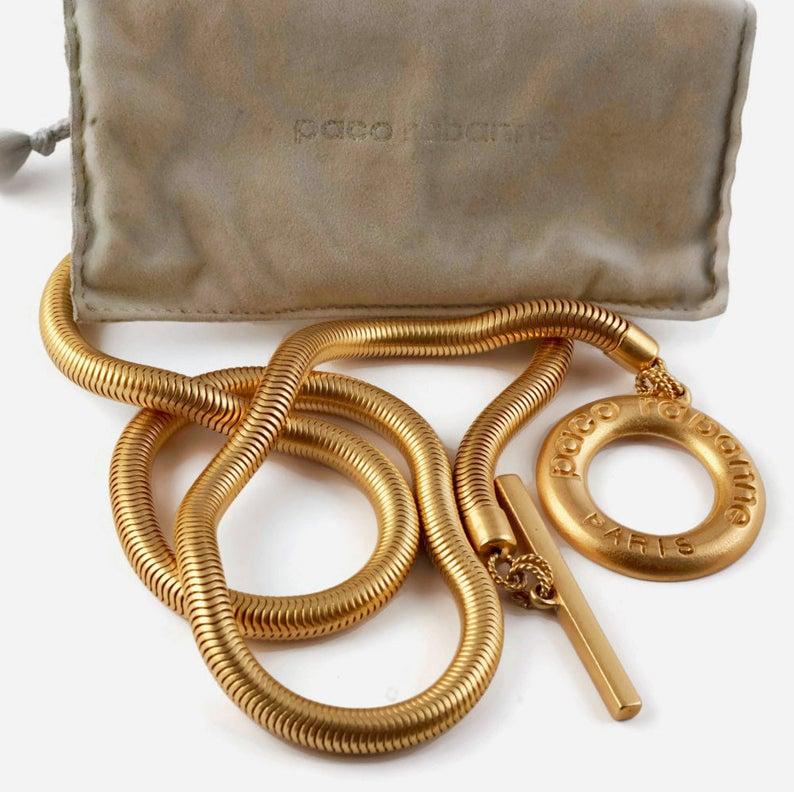 Vintage Long PACO RABANNE Logo Snake Chain Necklace

Measurements:
Logo Ring: 1 7/8 inches (4.76 cms)
Wearable Length: 34 inches (86.36 cms)

Features:
- 100% Authentic PACO RABANNE.
- Chunky and long snake chain.
- Signed PACO RABANNE on the ring