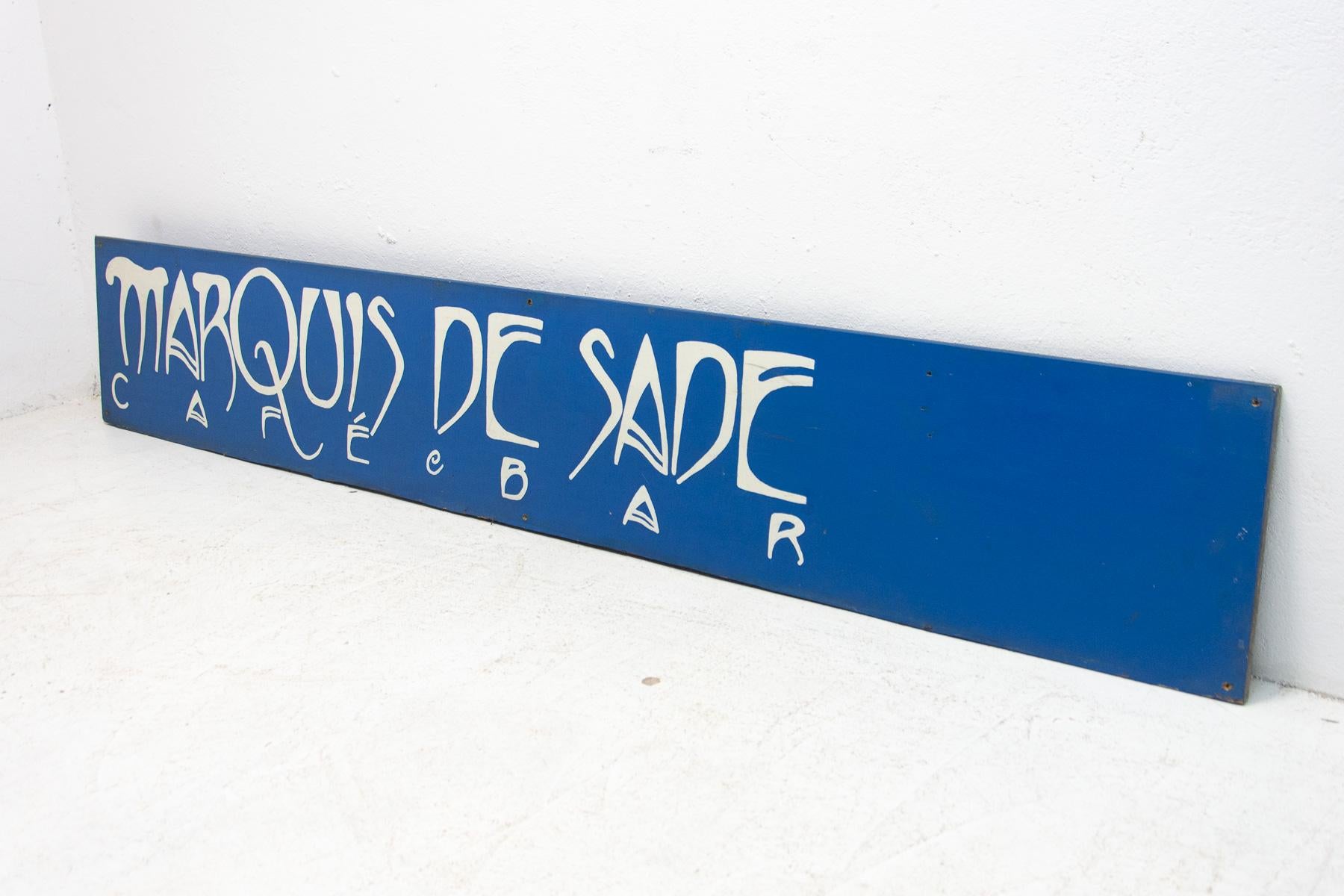 The sign comes from the former bar “Marquis de Sade” in the center of Prague. Made around 2010. Material wooden plywood sprayed with varnish.

 

Lenght: 250 cm

Height: 40 cm

Depth: 2 cm.