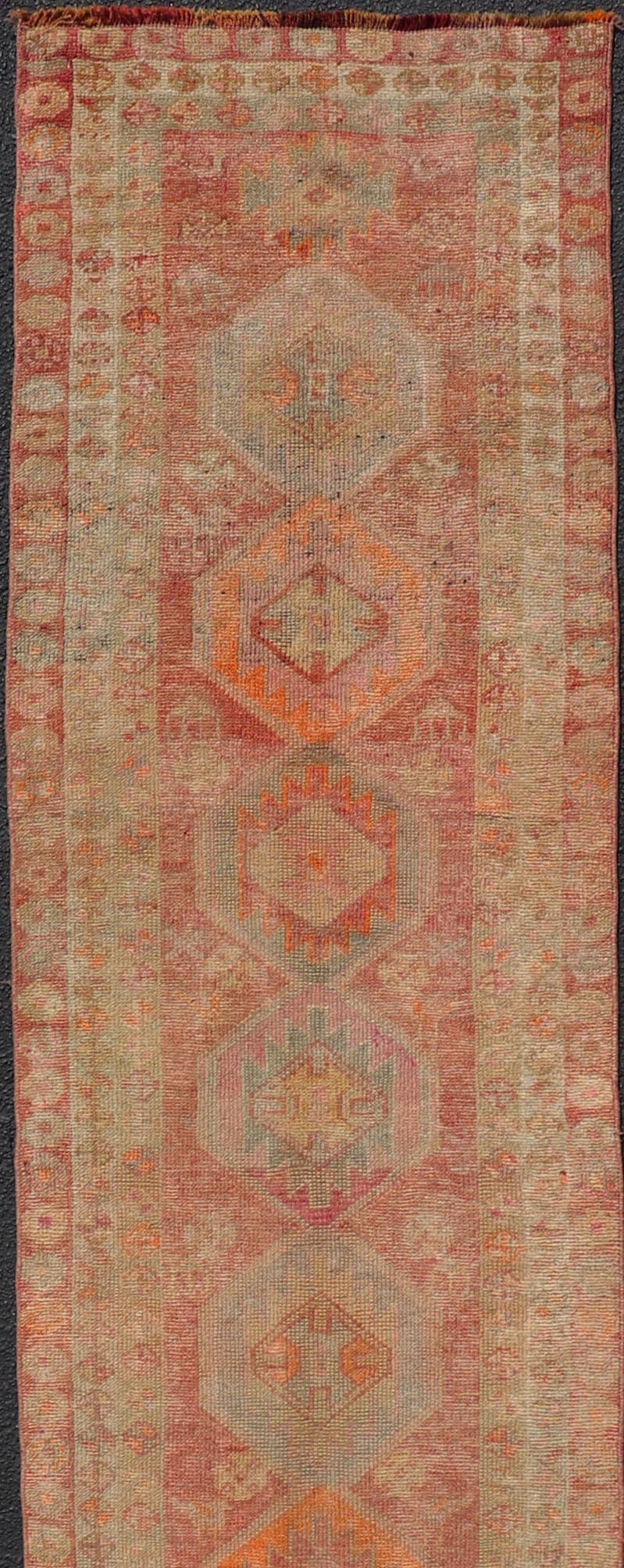 Wool Vintage Long Turkish Oushak Runner with Tribal Medallions in Soft Red For Sale