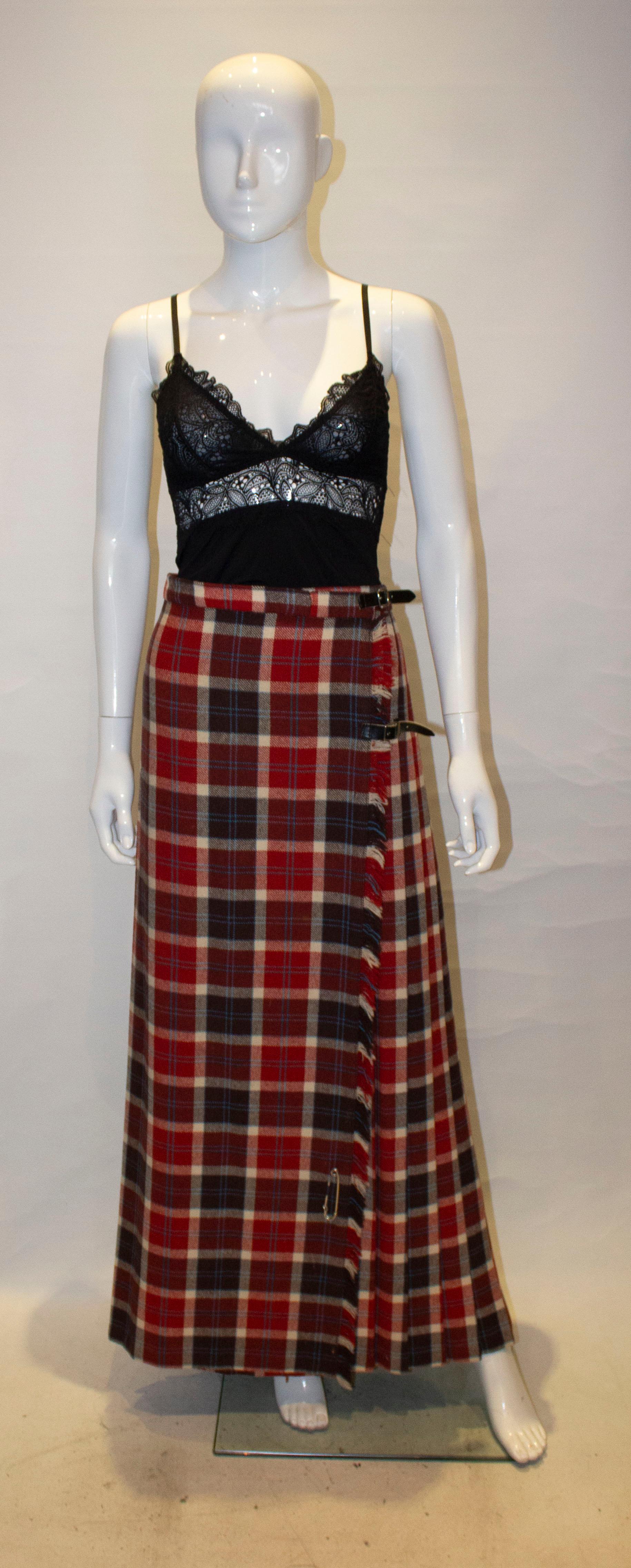 A chic vintage full length kilt in a red , black and dream check. The pleats are sewn down over the rear and so produce a flattering shape.