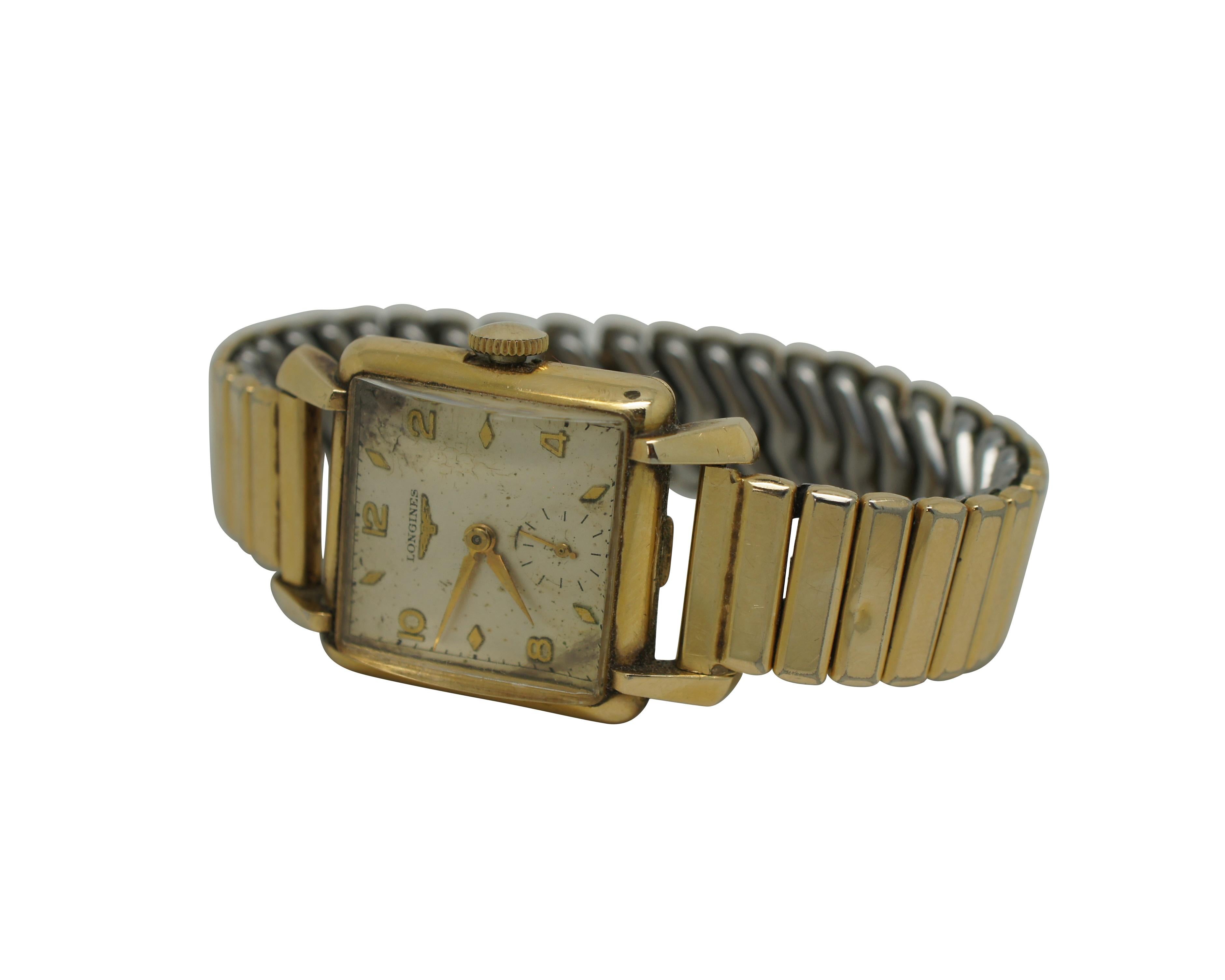 Vintage Longines 10k gold filled wrist watch featuring a Pontiac strech band.  Circa 1950s, Ser.# 7915121

The original serial number 7'915'121 identifies a wristwatch in yellow gold plated bearing the reference 6069. It is fitted with a Longines
