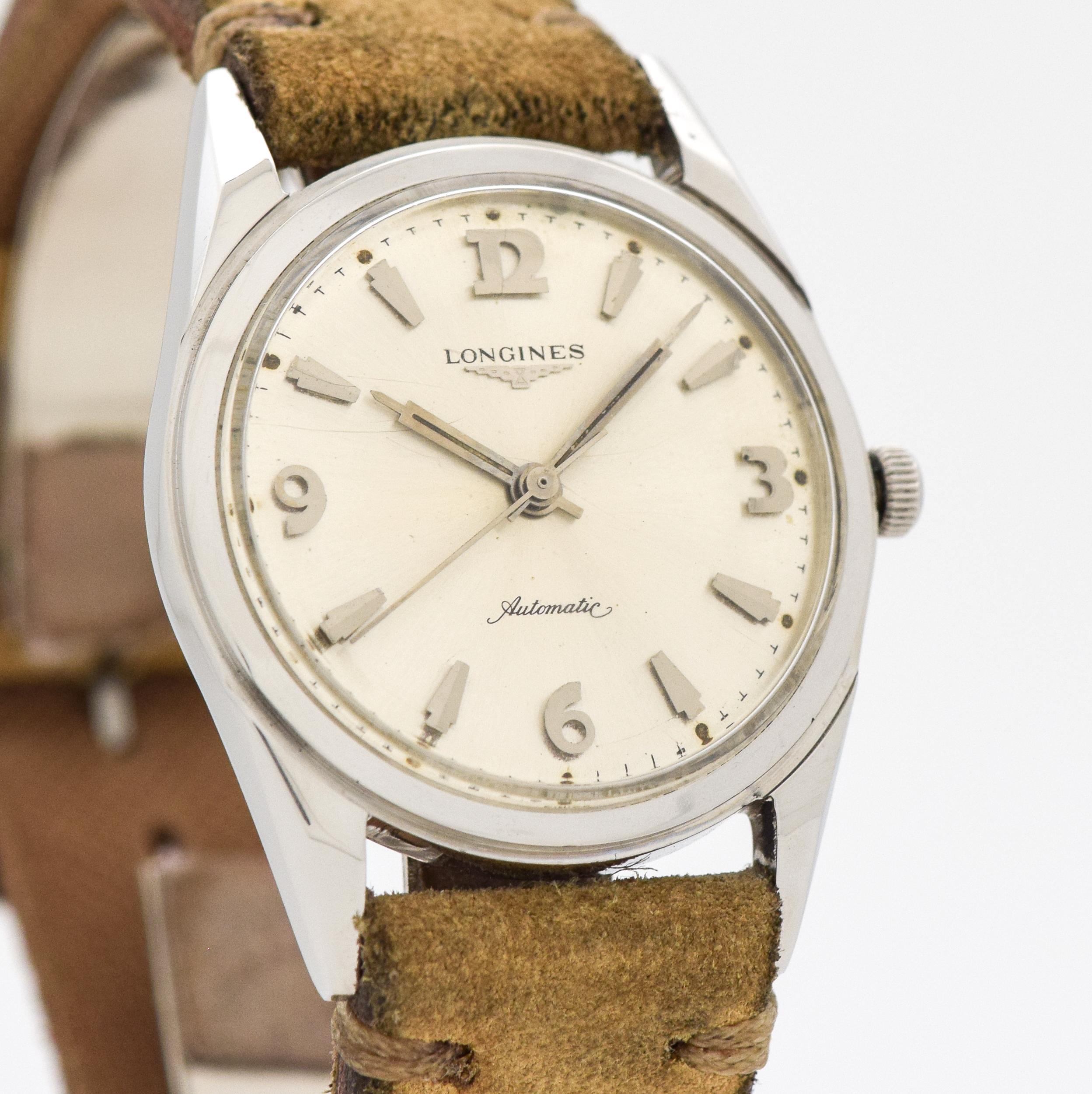 1961 Vintage Longines Ref. 2534 Stainless Steel watch with Original Silver Dial with Applied Steel Arabic 3, 6, 9, and 12 with Beveled Arrow Markers. 34mm x 42mm lug to lug (1.34 in. x 1.65 in.) - 17 jewel, automatic caliber movement. Equipped with
