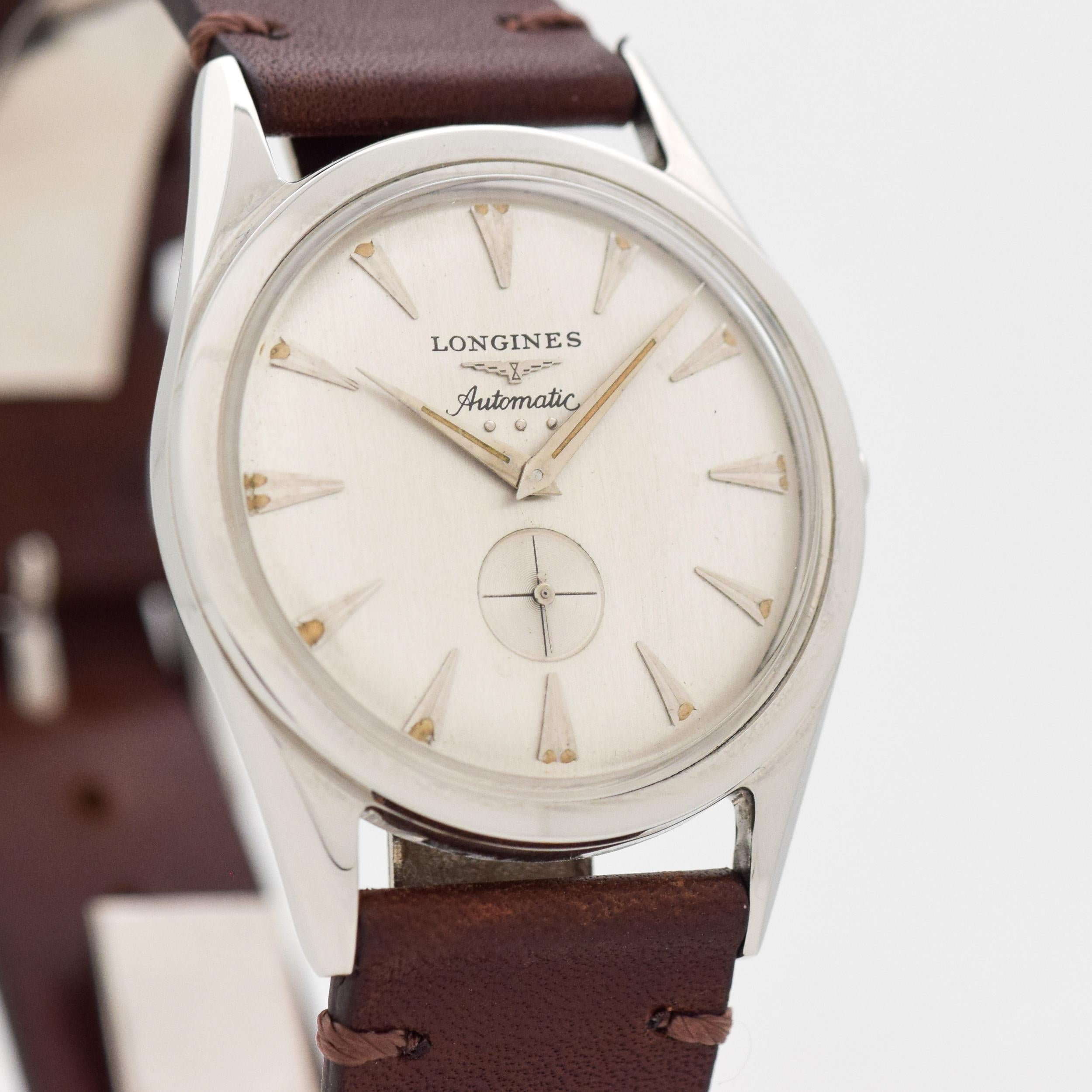1956 Vintage Longines Ref. 2220-P Stainless Steel watch with Original Solver Dial with Allied Steel Beveled Triangle Markers. 33mm x 41mm lug to lug (1.3 in. x 1.61 in.) - 20 jewel, automatic caliber movement. Equipped with a Horween Genuine Leather
