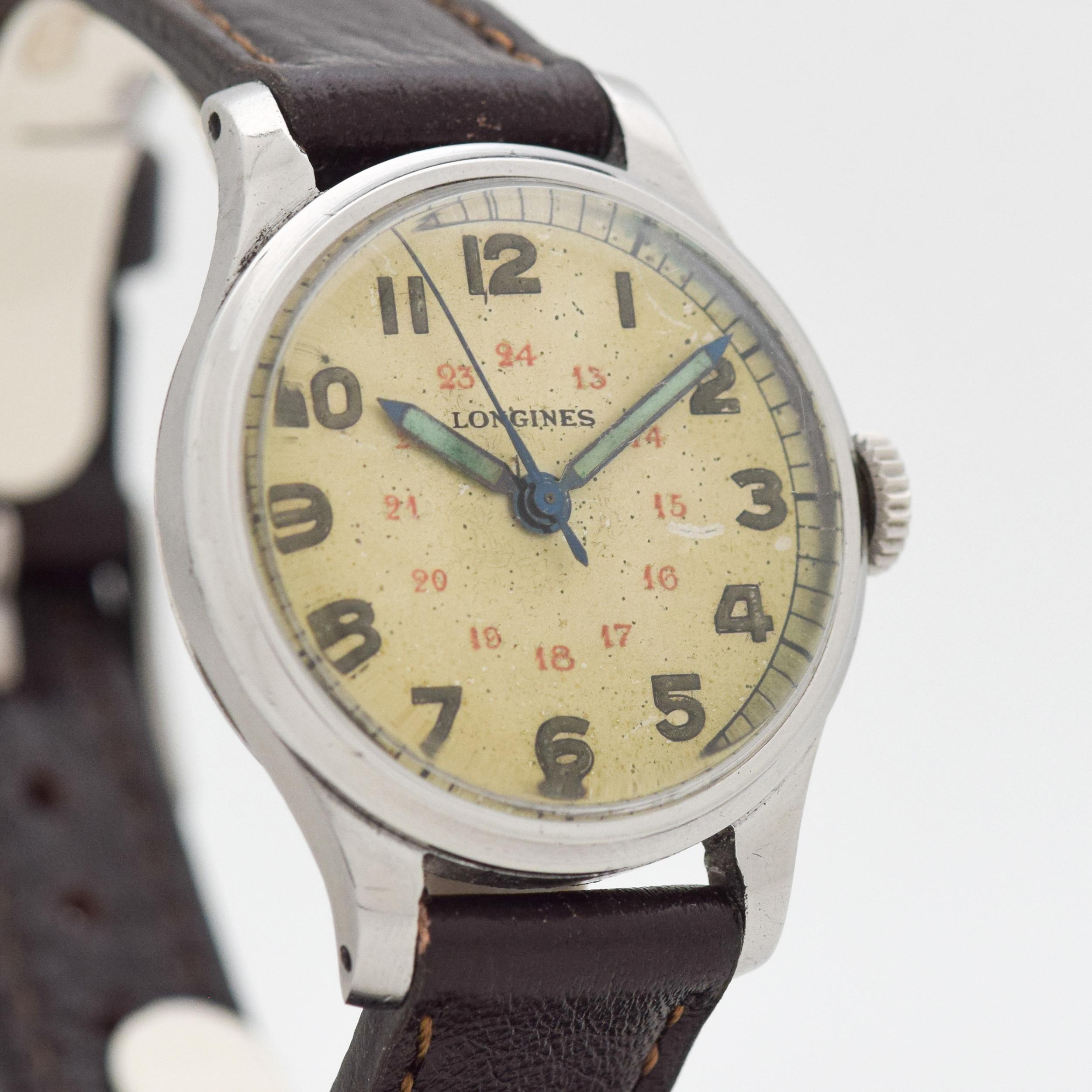 A 1944 Vintage Longines Military WWII-era wristwatch. Chrome & Stainless Steel example. 32mm wide. Original, patinated silver dial, aged with time. Powered by a 17-jewel, manual caliber movement. Equipped with a Genuine Leather Dark