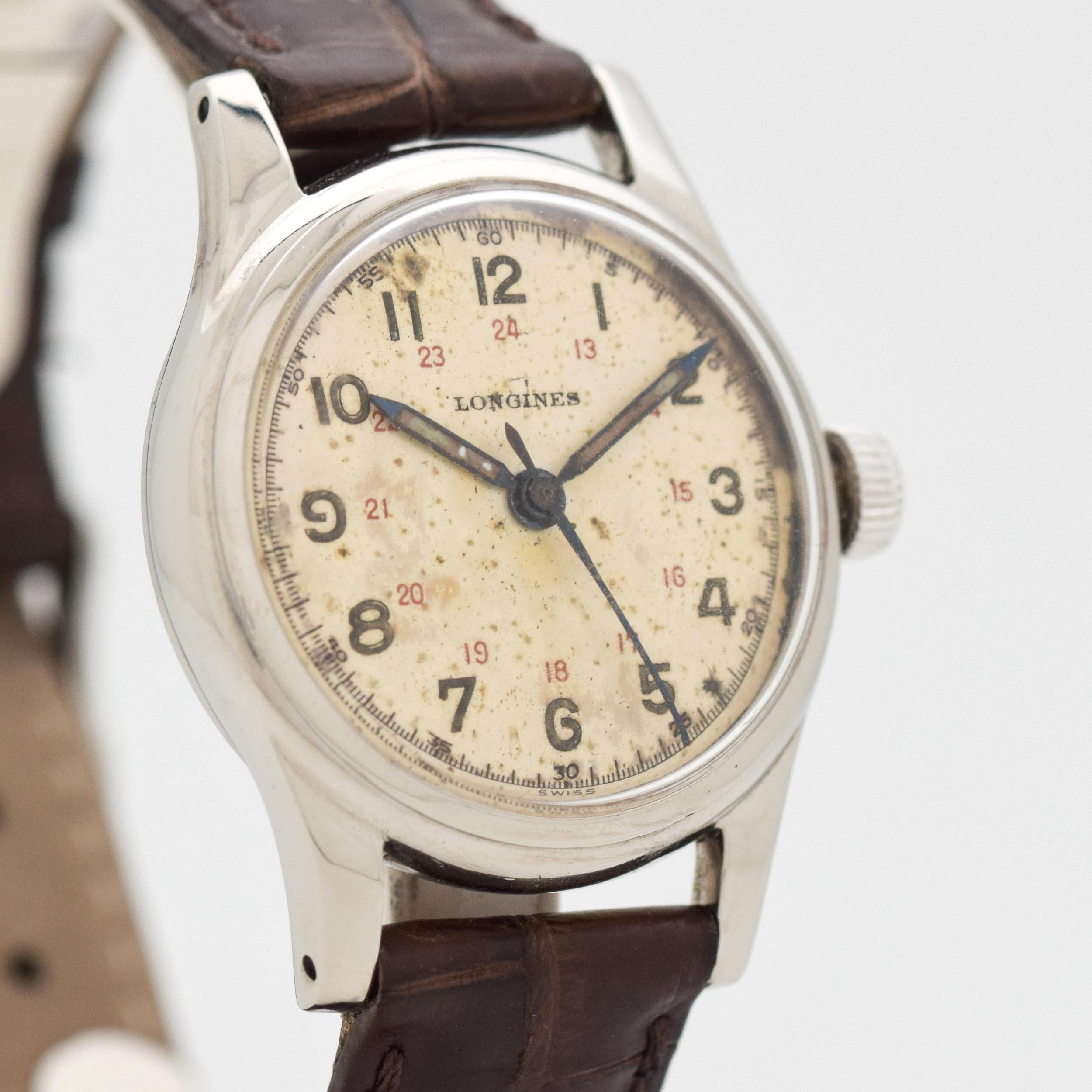 1949 Vintage Longines RARE and COLLECTIBLE Post WWII Military Stainless Steel watch with Original Silver Dial with Both 1 - 12 and 13 - 24 Hour Arabic Numbers. Case size, 32mm x 39mm lug to lug (1.26 in. x 1.54 in.) - Powered by a 17-jewel, manual