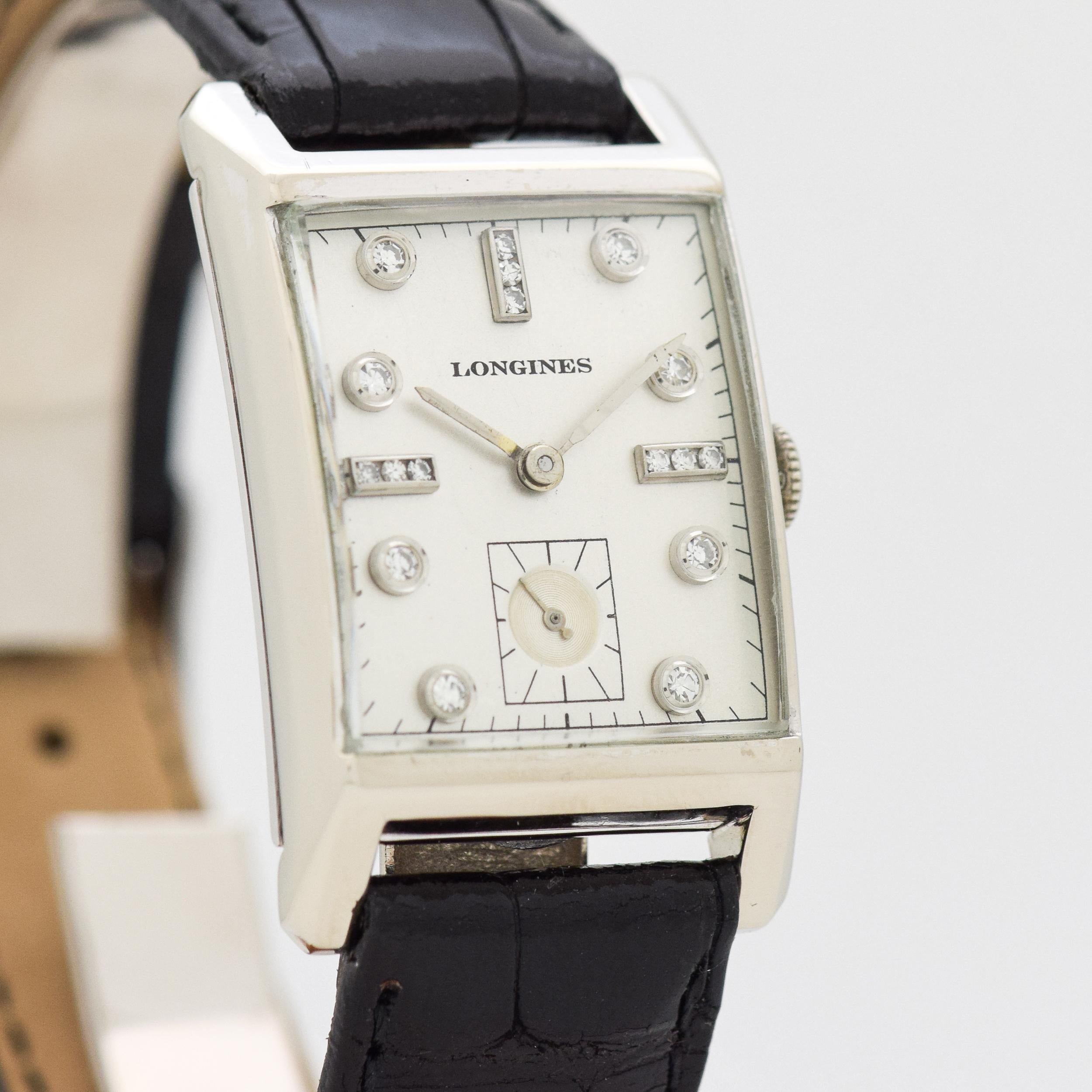 1950 Vintage Longines 14k White Gold watch with Silver Dial with Applied Framed Diamond Dot and Bar Markers. 23mm x 39mm lug to lug (0.91 in. x 1.54 in.) - 17 jewel, manual caliber movement. Featured on a 100% Genuine Alligator Glossy Black Strap.