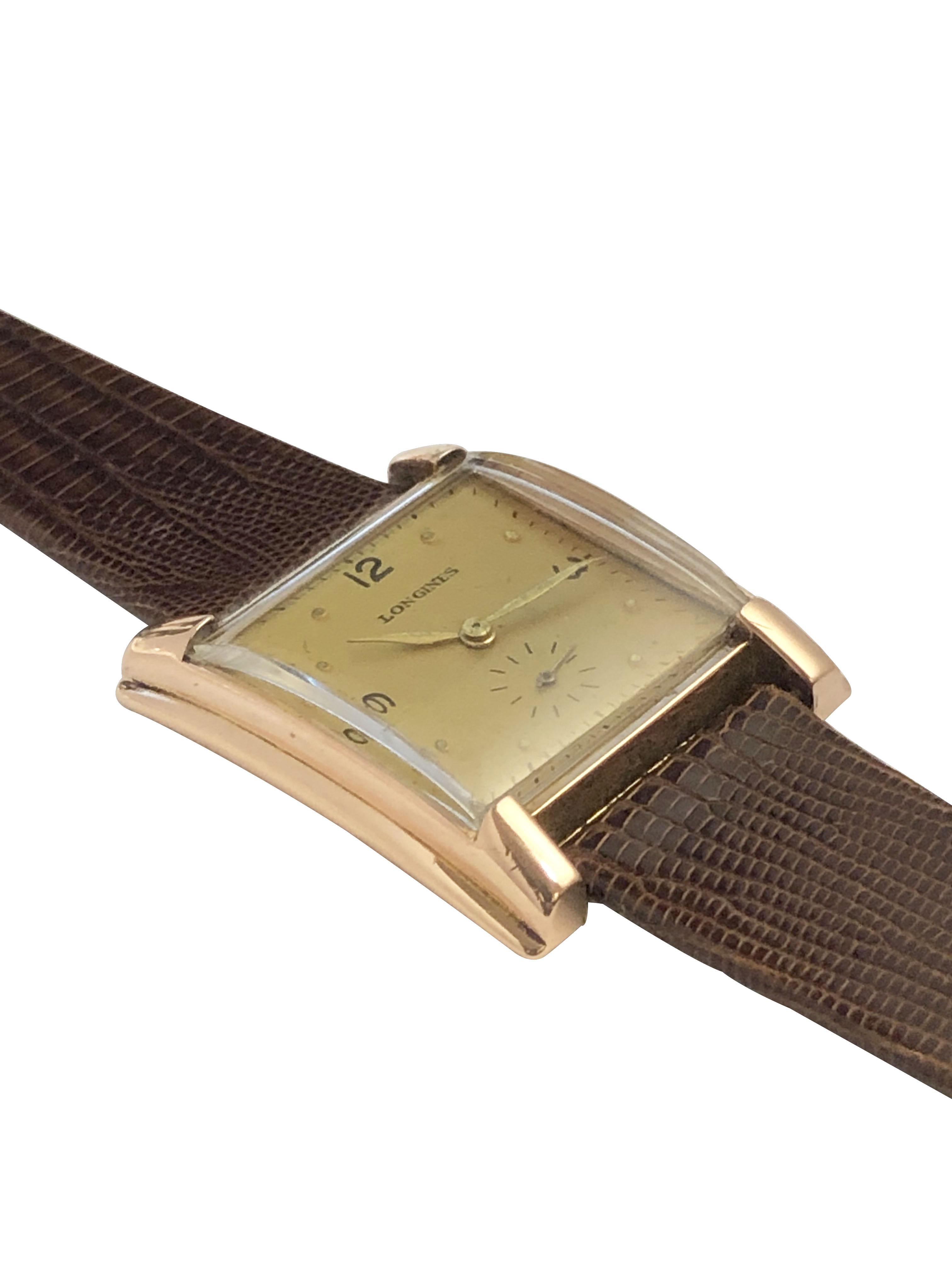 Circa late 1940s Longines Wrist Watch, 29 X 25 M.M. 14k Rose Gold 2 Piece stepped sides case, 17 Jewel Mechanical, manual wind movement, Gold Tone dial with raised Markers and a sweep seconds hand. New Brown Lizard Strap. Recently serviced and comes