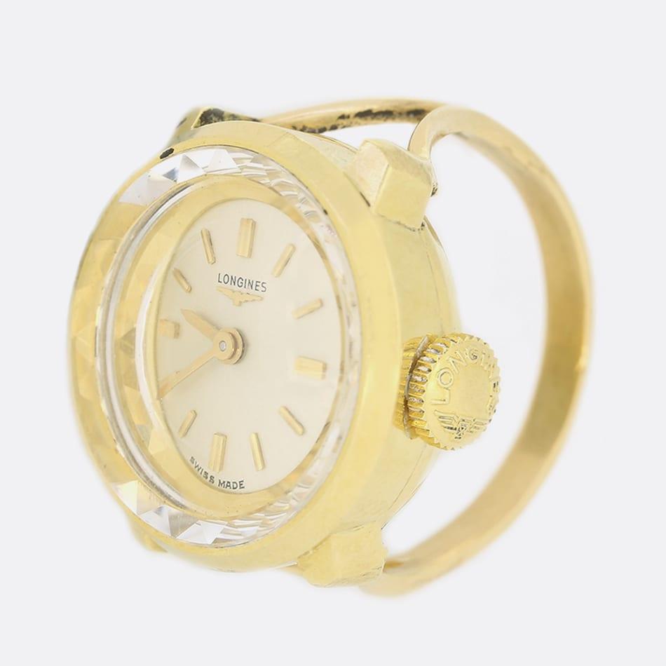 This is a wonderful Vintage Longines watch ring. It features a circular face with a cream dial, gold hour markers and gold hands. The watch has all its original parts including the dial, crown and hands. The watch has a 18ct yellow gold case and a