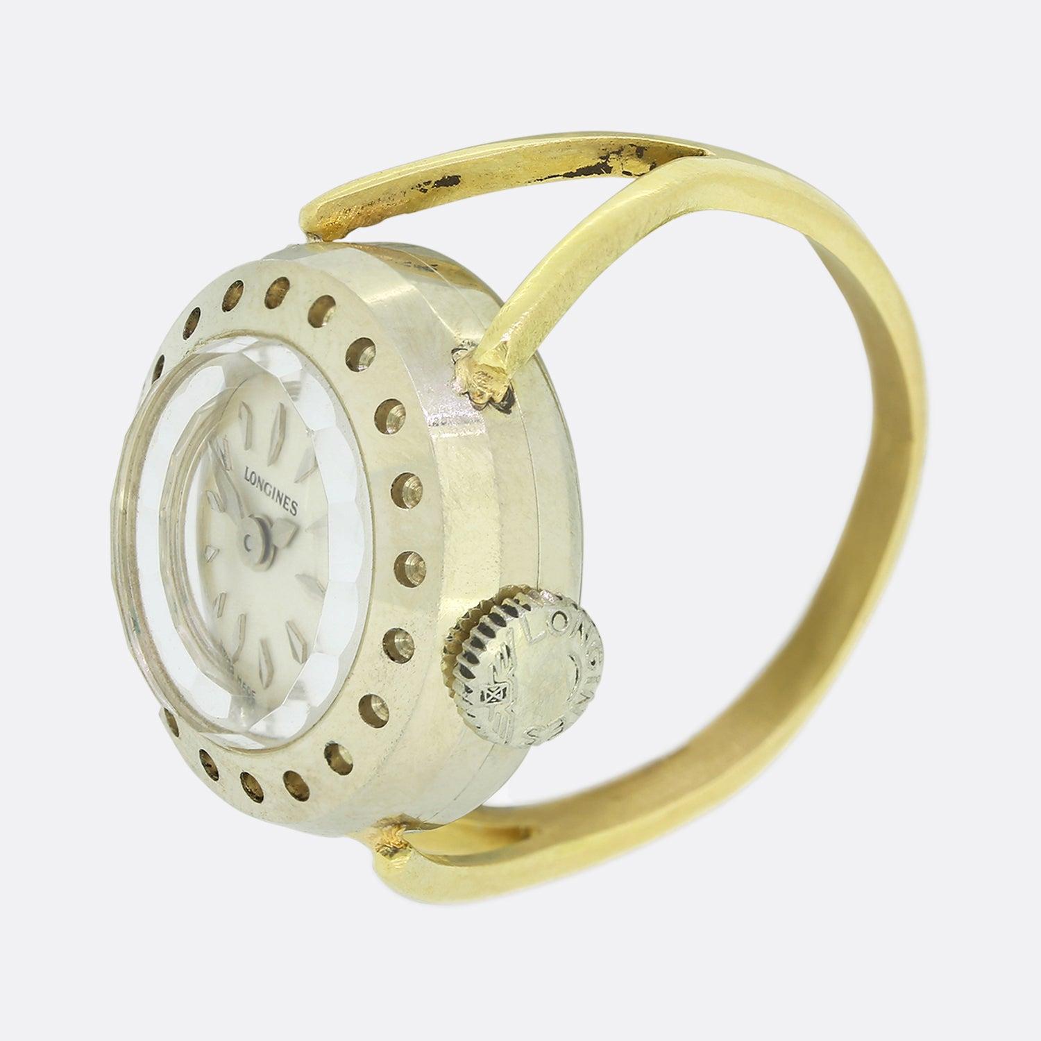 This is a wonderful Vintage Longines watch ring. It features a circular face with a silver dial, silver hour markers and silver hands. The watch has all its original parts including the dial, crown and hands. It has a steel case and an 18ct gold