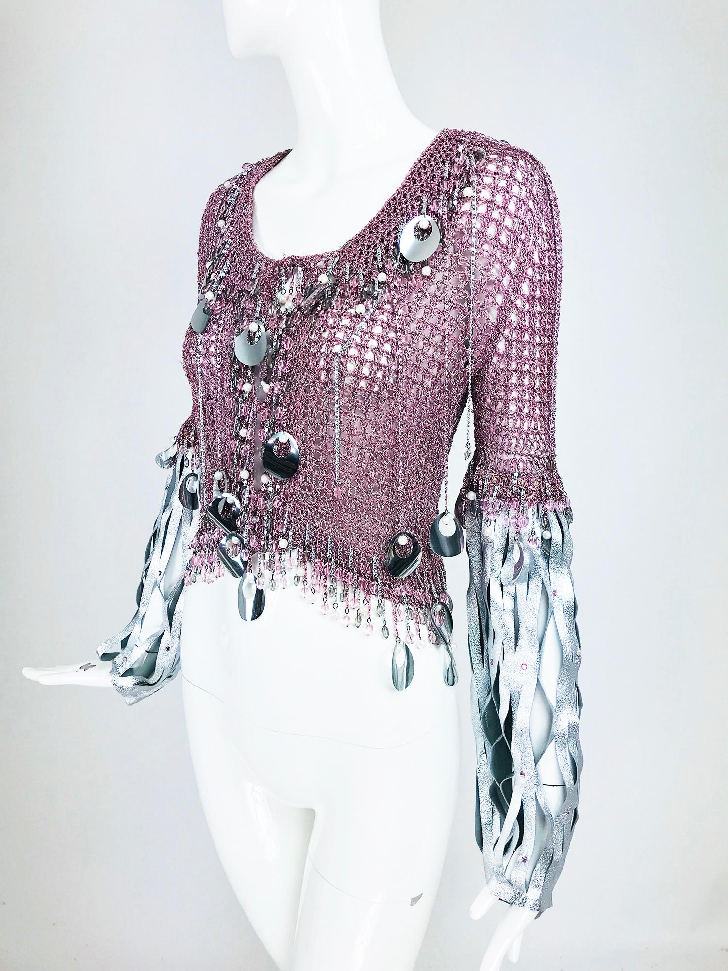 Vintage Loris Azzaro metallic pink and silver leather sweater from the 1980s. Pinks and silver metallic thread are crocheted together to create this sparkly sweater. In addition, the sweater has metal chains at the neck front and back of various
