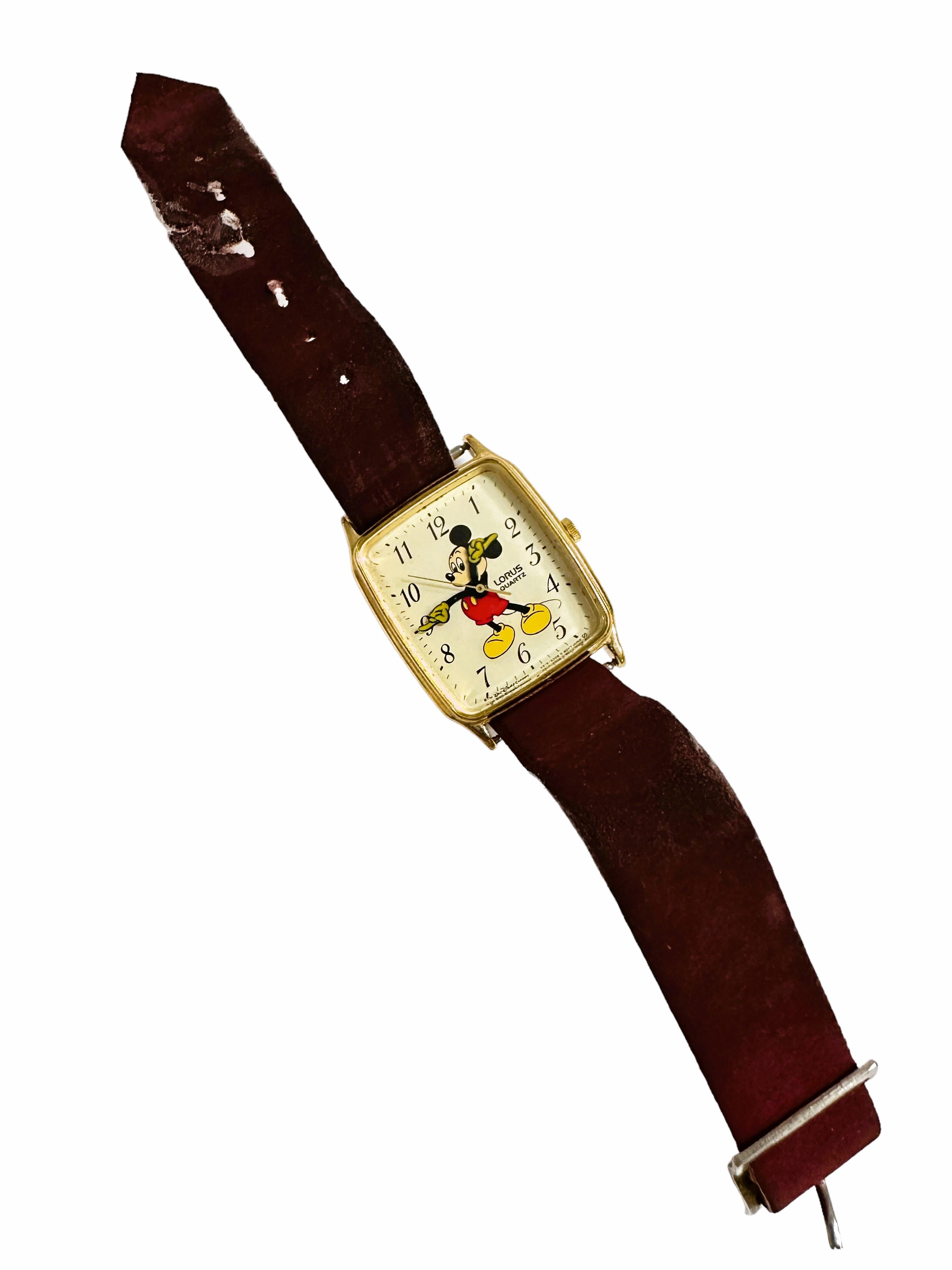This vintage Lorus/Seiko wristwatch features a charming Disney Mickey Mouse design on a gold dial housed in a gold stainless steel rectangle case
 measuring 36 x 26 mm.  Rectangle cases are not very common.  Most of these come in round cases. The