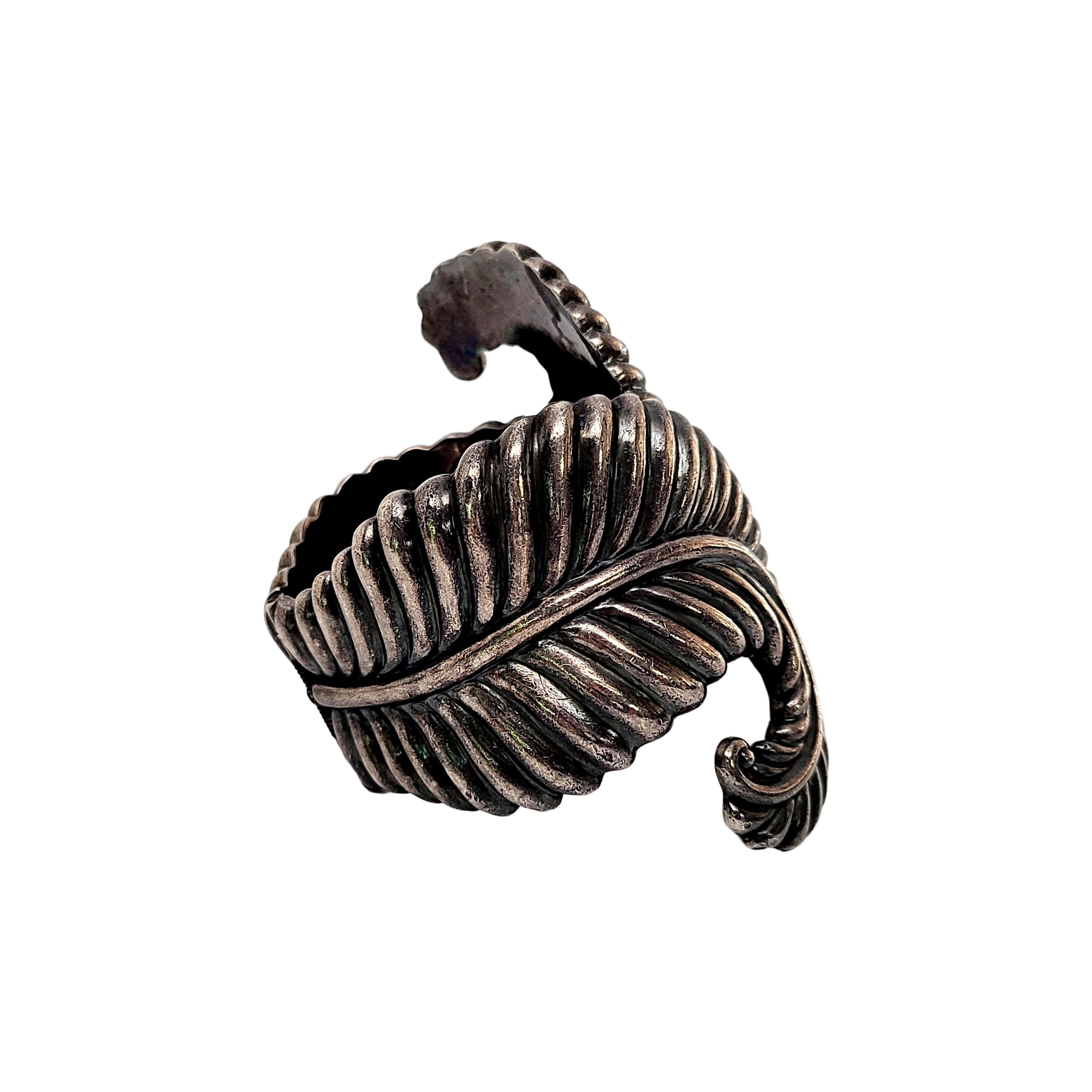Sterling silver clamper bracelet by Los Castillo of Mexico, circa 1950s.

Renowned Mexican silversmith, Los Castillo, designed this large and substantial clamper bracelet, design #238. It features curved fern fronds with a spring hinge.

Measures