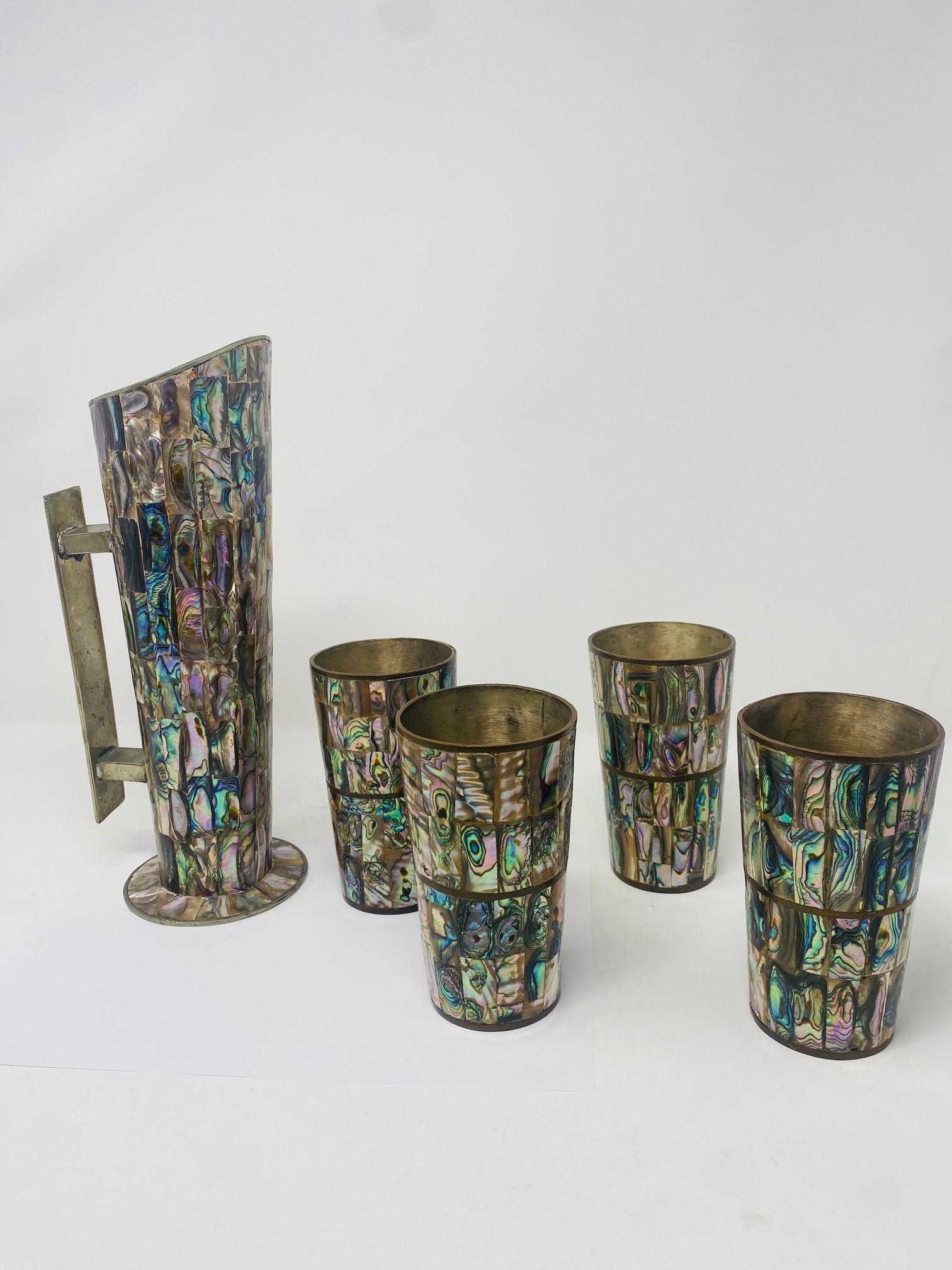 Los Castillo pitcher with beautiful abalone shell and matching set of abalone shell cups. Marked Alpaca Taxco. In great vintage condition.  This beautiful set is beyond fabulous.  Sculptural and organic, each piece glistens with beauty.  An