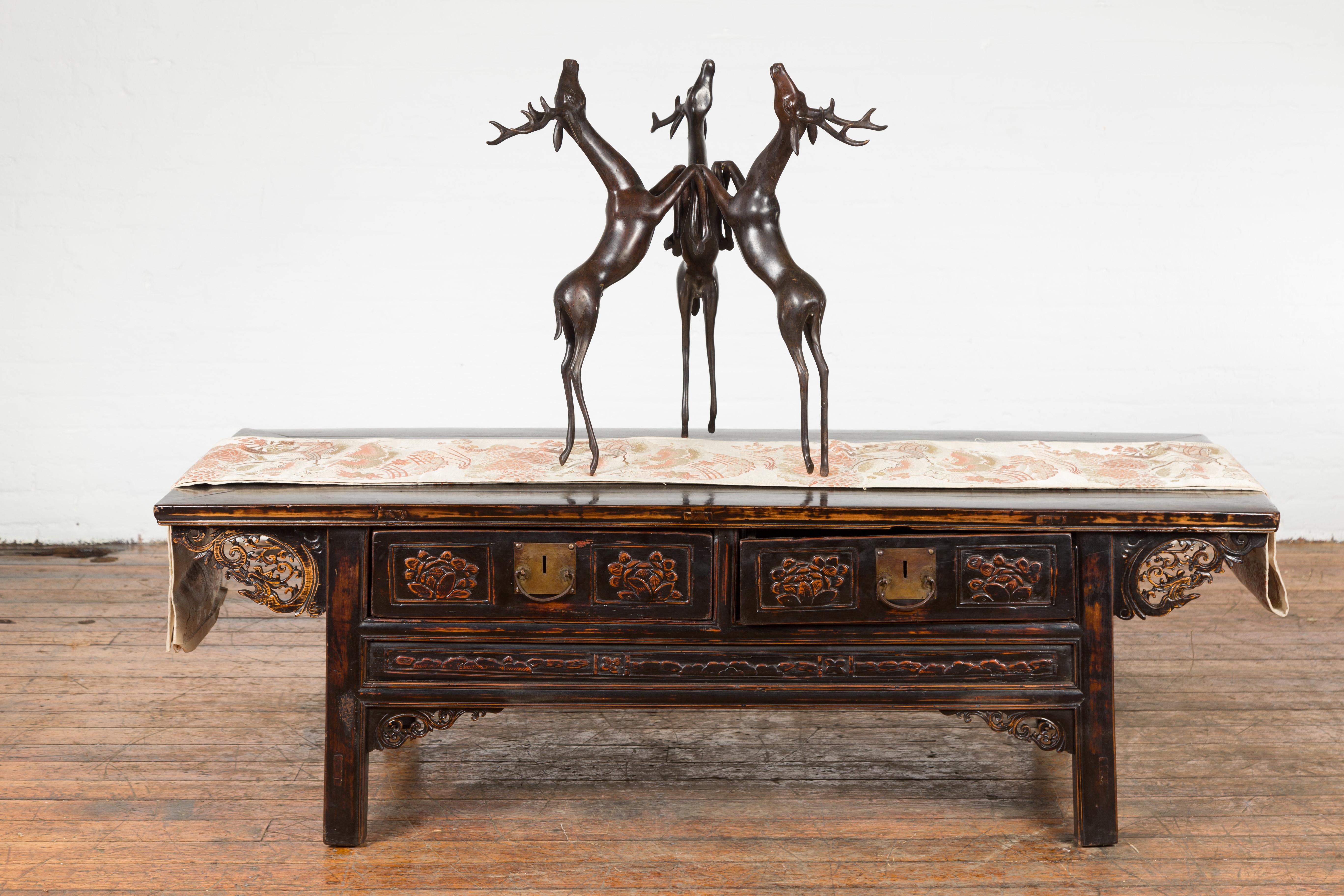 A vintage lost wax cast bronze triple deer low table base from the mid 20th century with bronze patina. Created with the traditional technique of the lost-wax (à la cire Perdue) which allows for great precision and finesse in the details, this