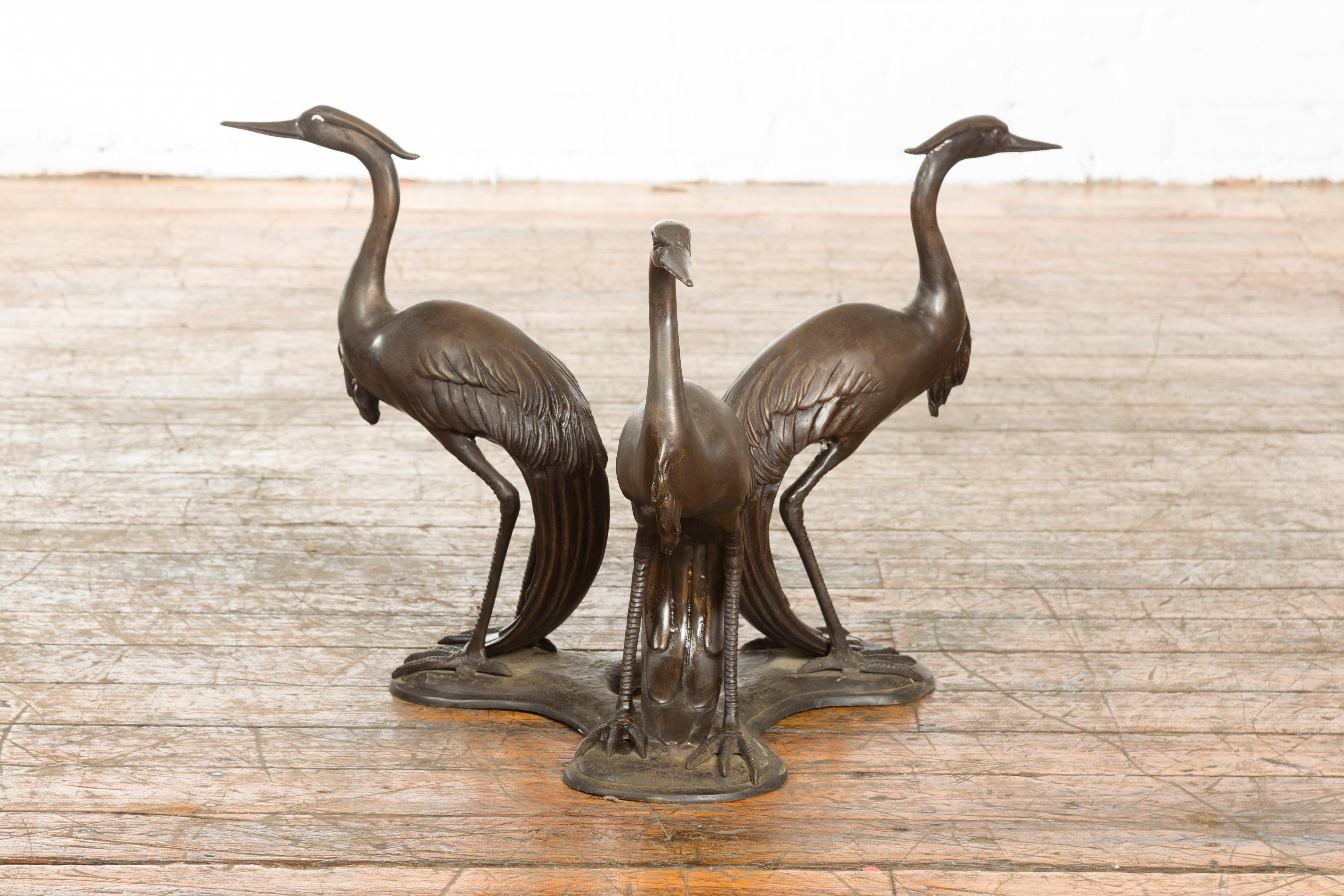 A vintage lost wax cast bronze triple heron coffee table base from the mid 20th century, with dark bronze patina. We currently have several available priced and sold $1,500 each. Created with the traditional technique of the lost-wax (à la cire
