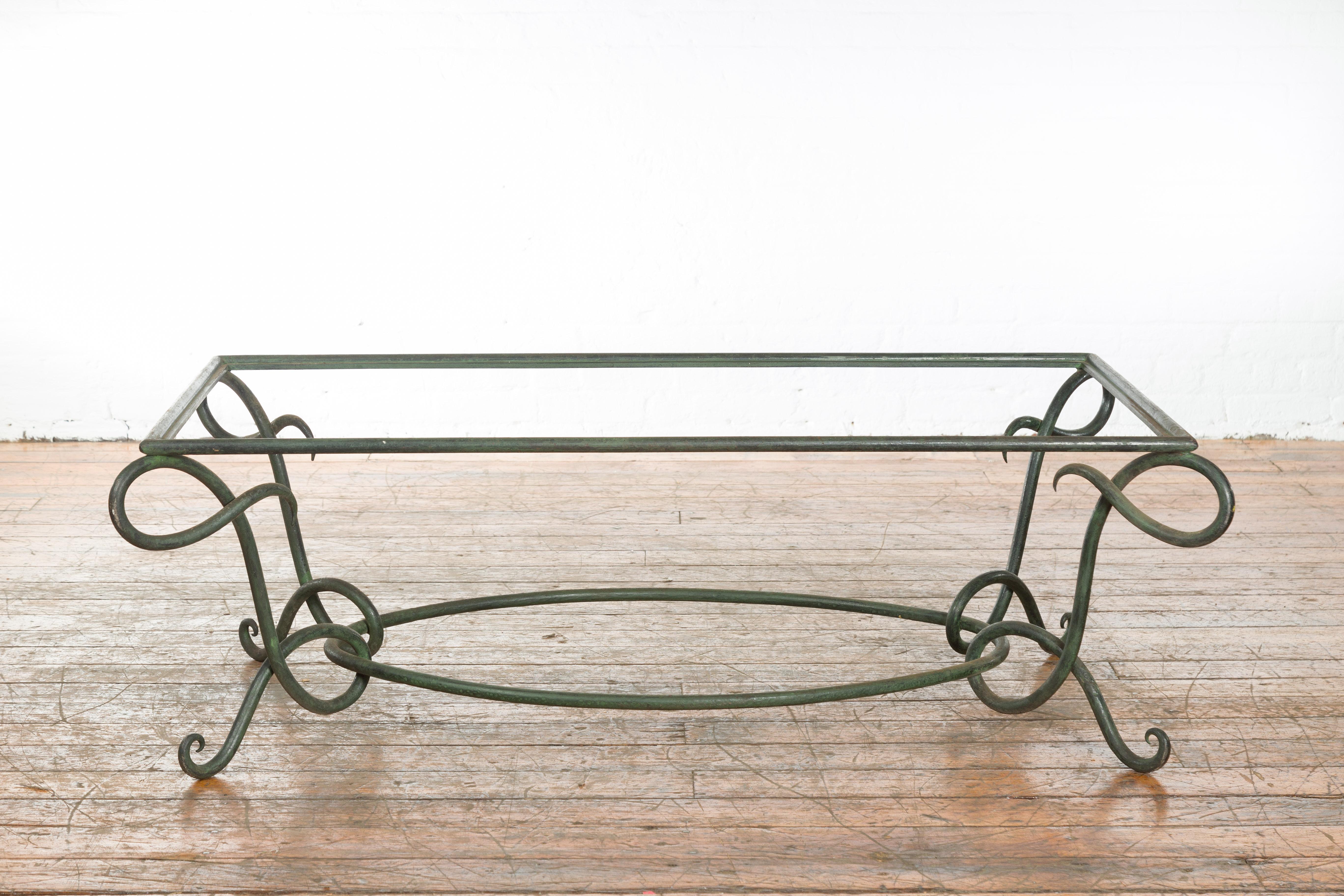 A vintage lost wax cast bronze coffee table base from the mid 20th century, with verde patina and L motifs. Created with the traditional technique of the lost-wax (à la cire perdue) which allows for great precision and finesse in the details, this