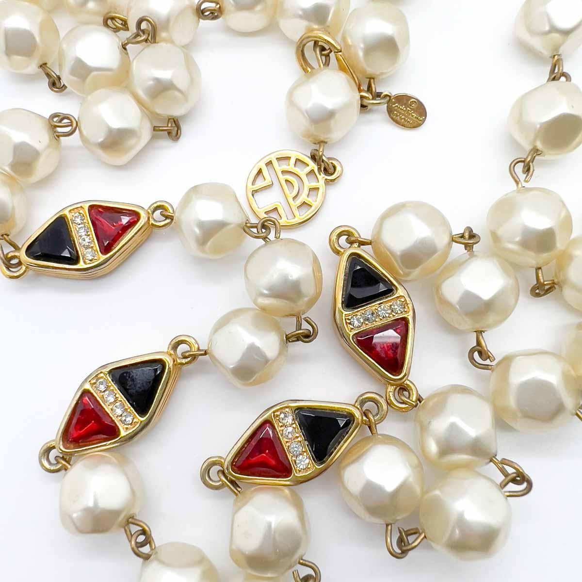 A Vintage Louis Féraud Pearl Necklace. Baroque inspired pearls punctuated with jewelled stations. Each station set with fancy cut crystals in ruby red and black finished with a row of tiny chatons. A perfectly timeless piece that oozes