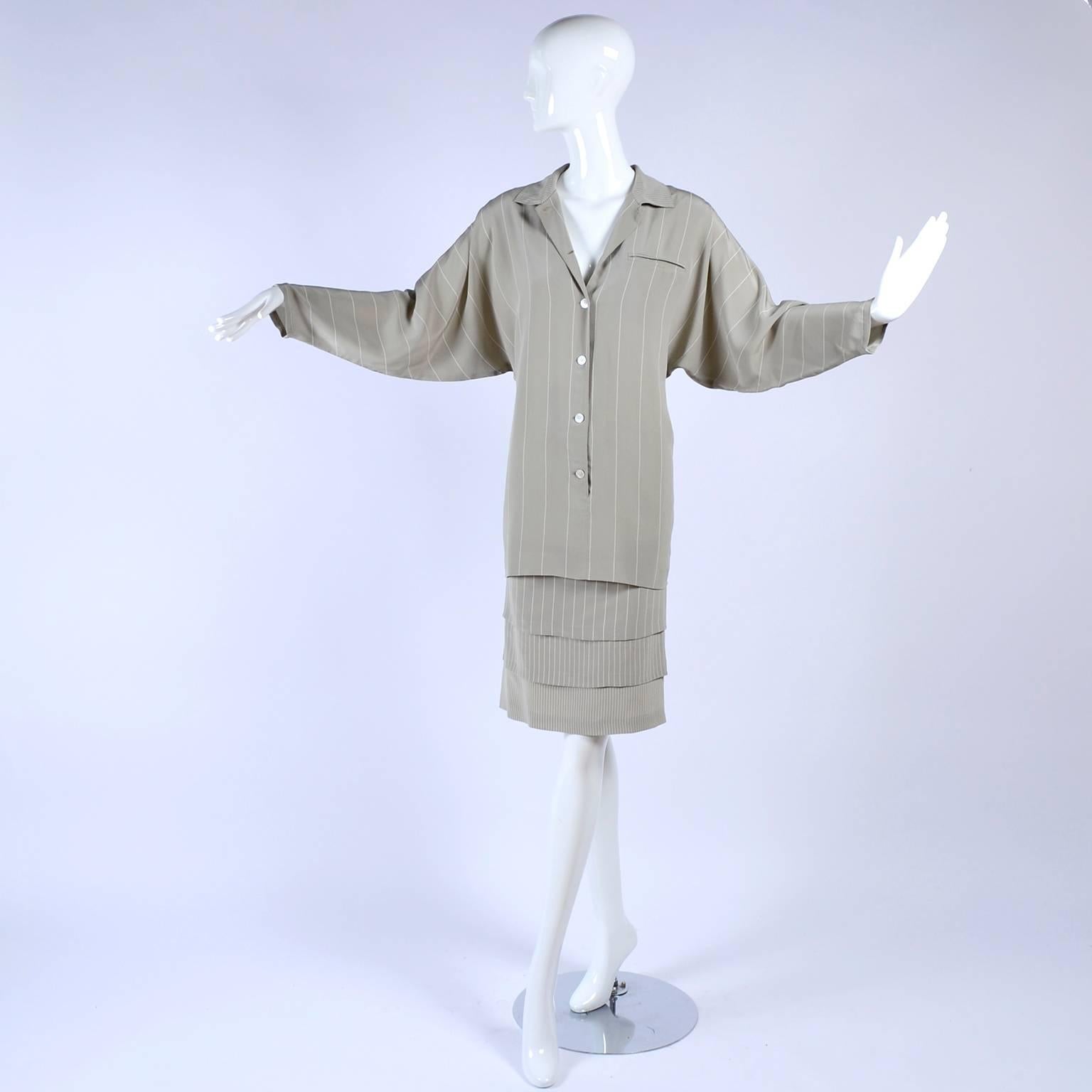 This vintage Louis Feraud dress can be worn effortlessly today and fit into modern styling!  The silk dress has thin white pinstripes, dolman sleeves, and a pretty tiered / layered hem.  The dress buttons up the front and was made in West Germany in