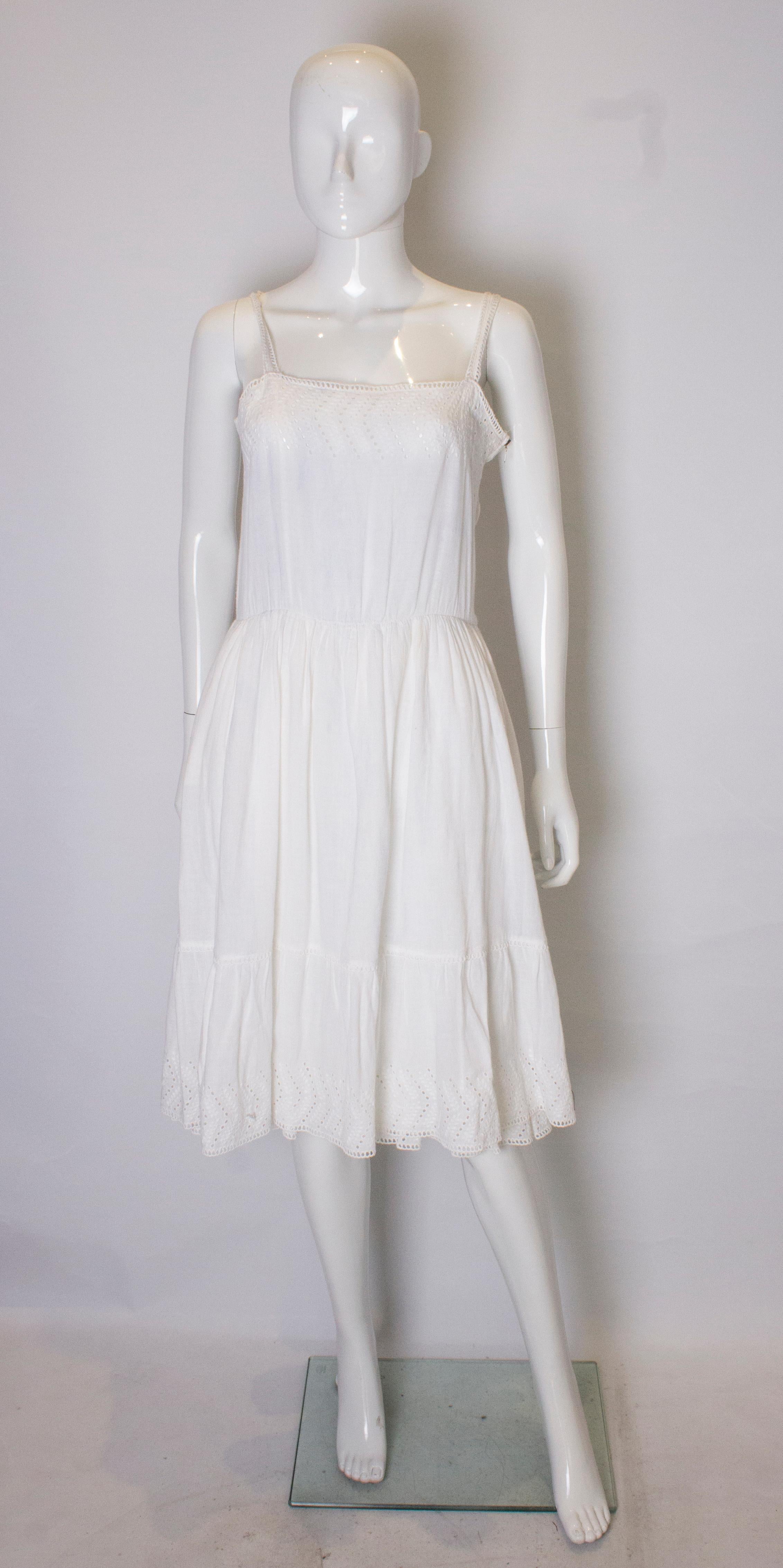 A great dress for Summer from  Louis Feraud. The dress has detail on the bodice , front and back,gathering at the waist, two layers of skirt and a frill at the hem. It has a side zip opening.