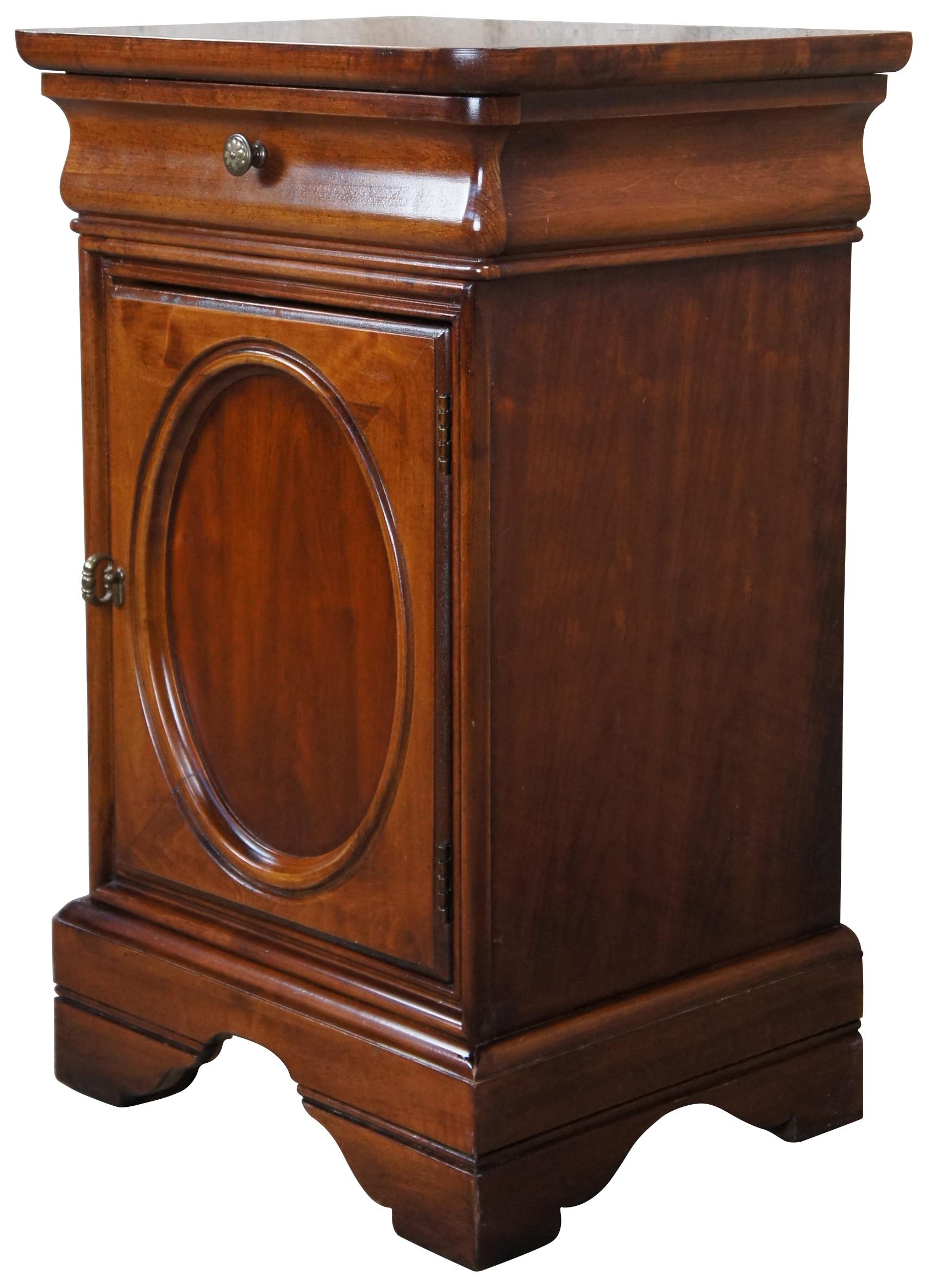 Late 20th Century Louis Phillipe Style Bedside Table or Nightstand.  Made from Cherry with an upper cornice drawer and lower cabinet with shelf.  Marked H 157-623, USA