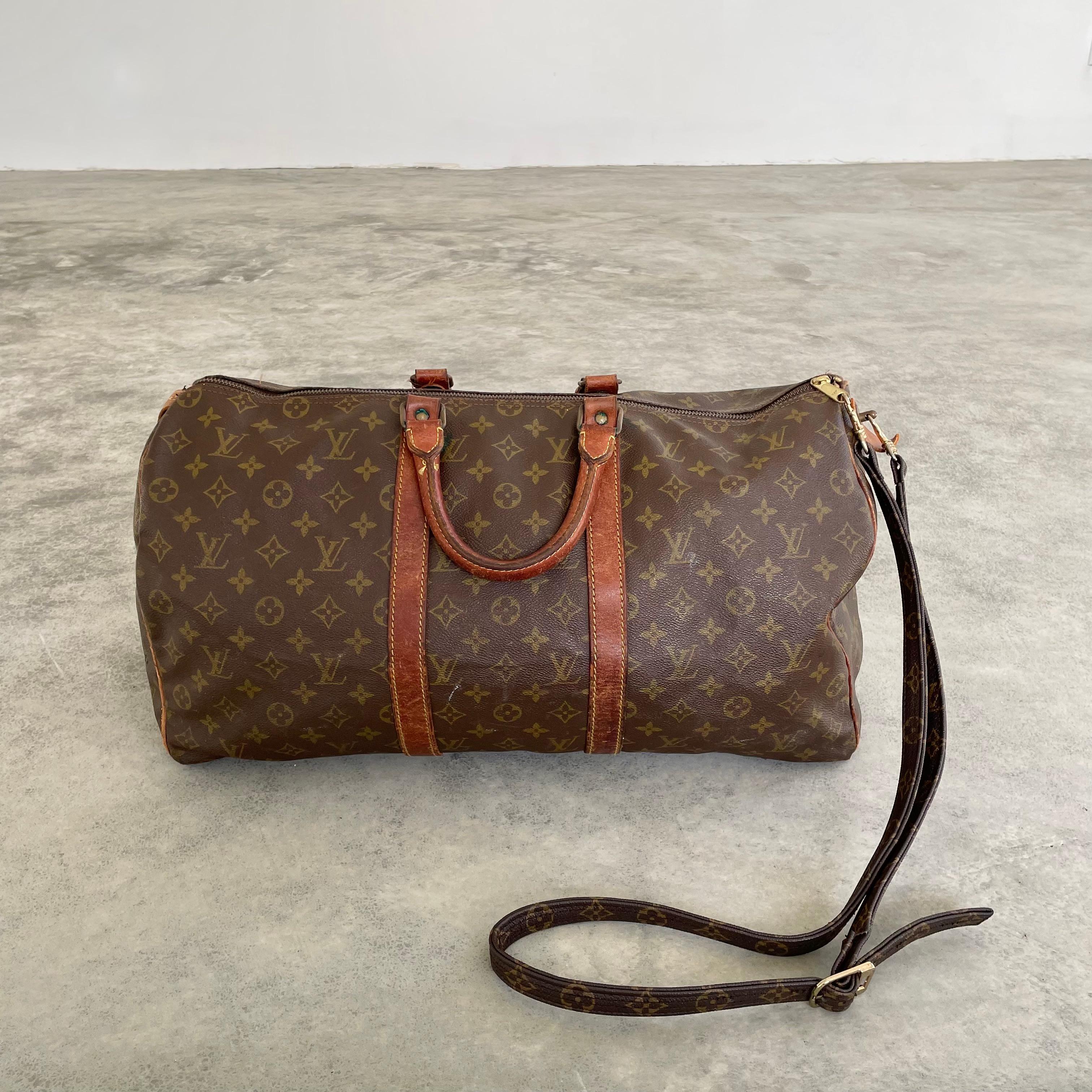 Classic vintage 1950s Louis Vuitton duffle bag. Perfect for weekend trips, this LV monogram print duffle is made with saddle leather and brass hardware and wrapped in the iconic Louis Vuitton canvas. Timeless simplicity in design and iconic badging
