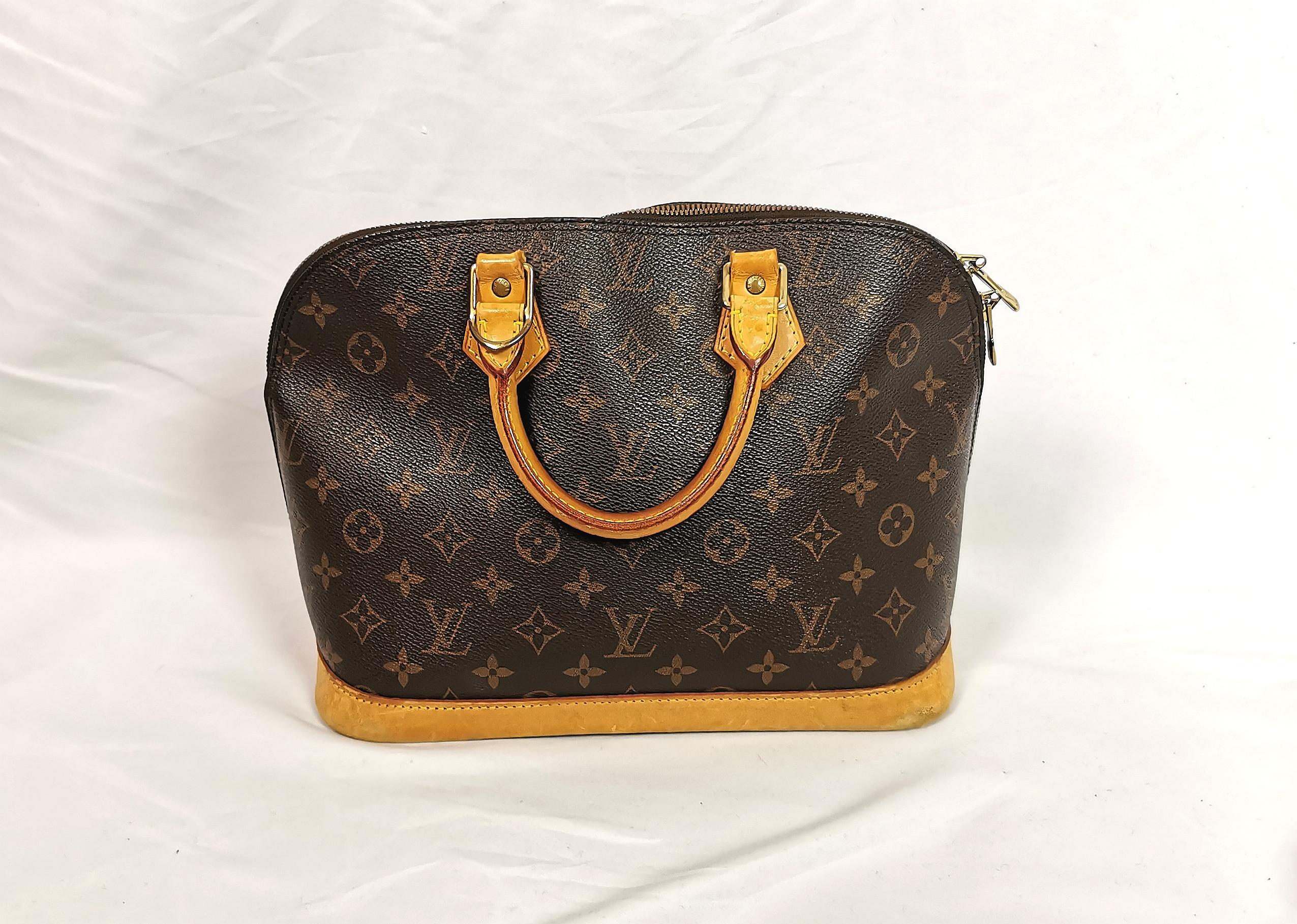 A gorgeous classic, Vintage Louis Vuitton Alma MM top handle handbag.

Coated canvas with the signature LV monogram design, Vachetta leather trim and handles with gold tone hardware.

Lined in brown cotton fabric.

This design is a true staple for