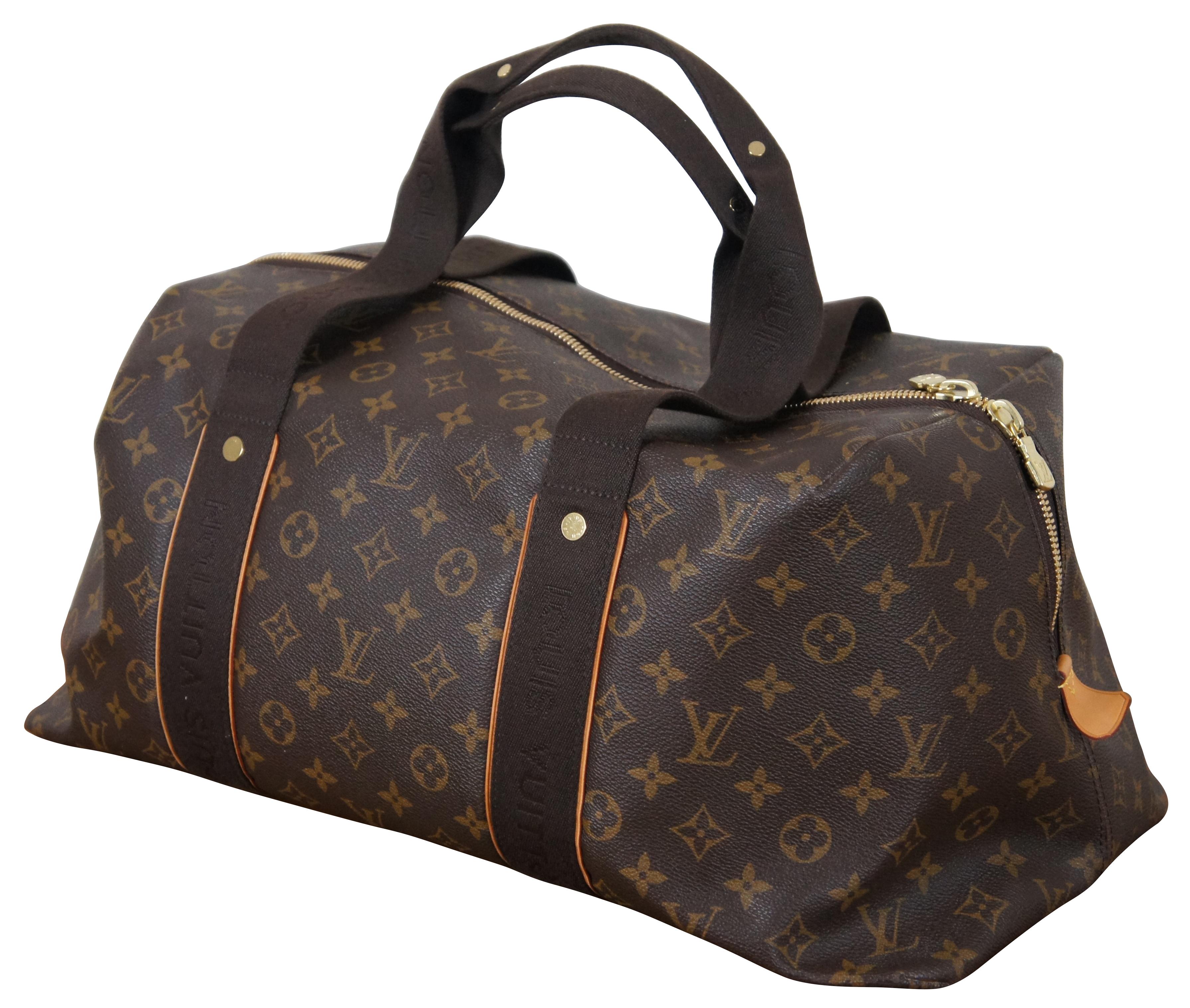Vintage Louis Vuitton Beaubourg Weekender duffle bag crafted from brown monogram canvas with cowhide leather trim, canvas straps, and gold tone brass hardware. One slip pocket on front and six interior organizational pockets. Serial Number DU2161. 