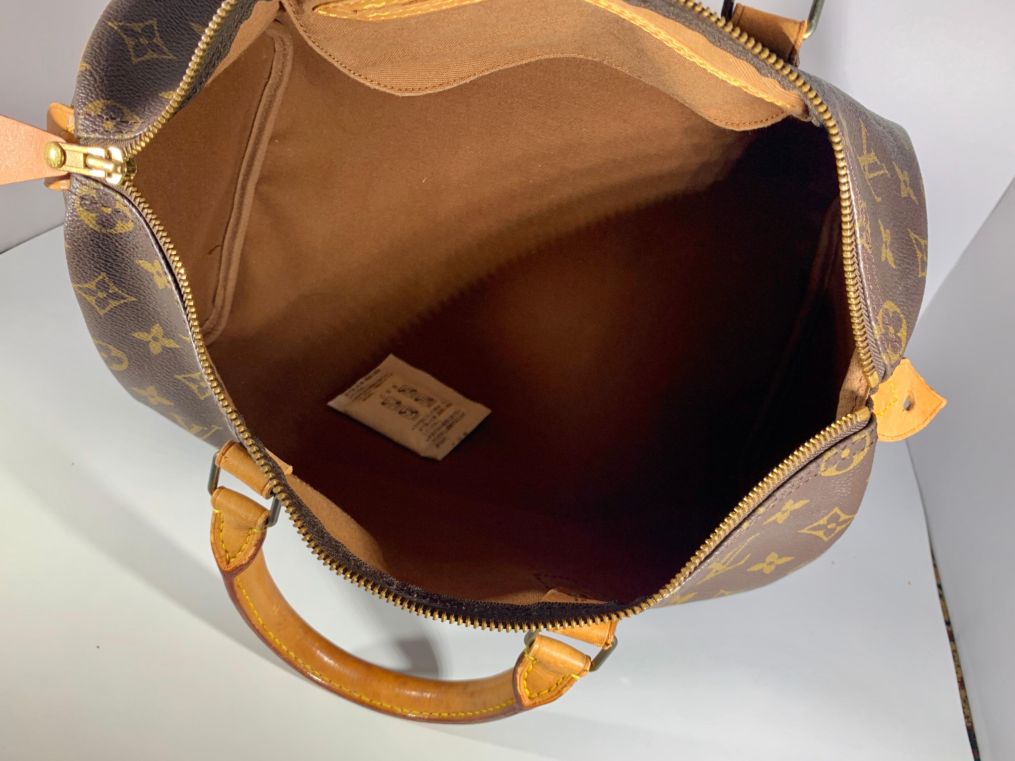 A Vintage  Louis Vuitton logo-printed Louis Vuitton Speedy 30 with leather trim with bring a touch of heritage luxury wherever you carry it.
Over all Excellent condition for a vintage bag
No stain , no fading , lining is in great shape
No Louis