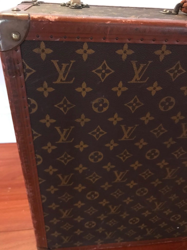 Louis Vuitton, a large and antique suitcase. Made of woo…