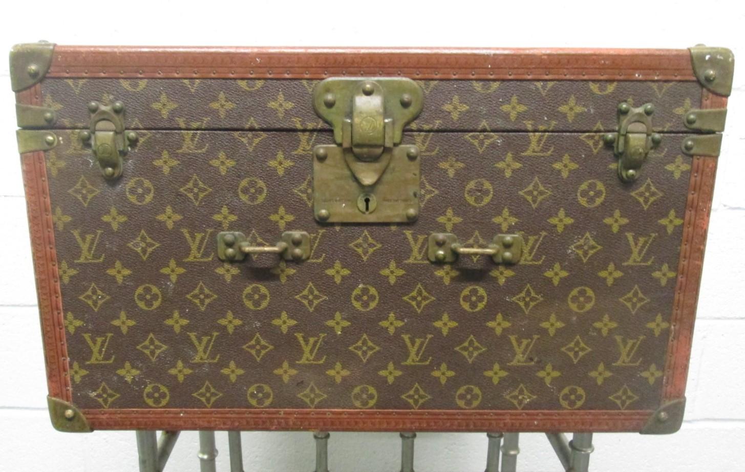 Vintage Louis Vuitton trunk / hat box. Has a silk interior with four corner pockets. Monogrammed on canvas with leather and brass hardware.