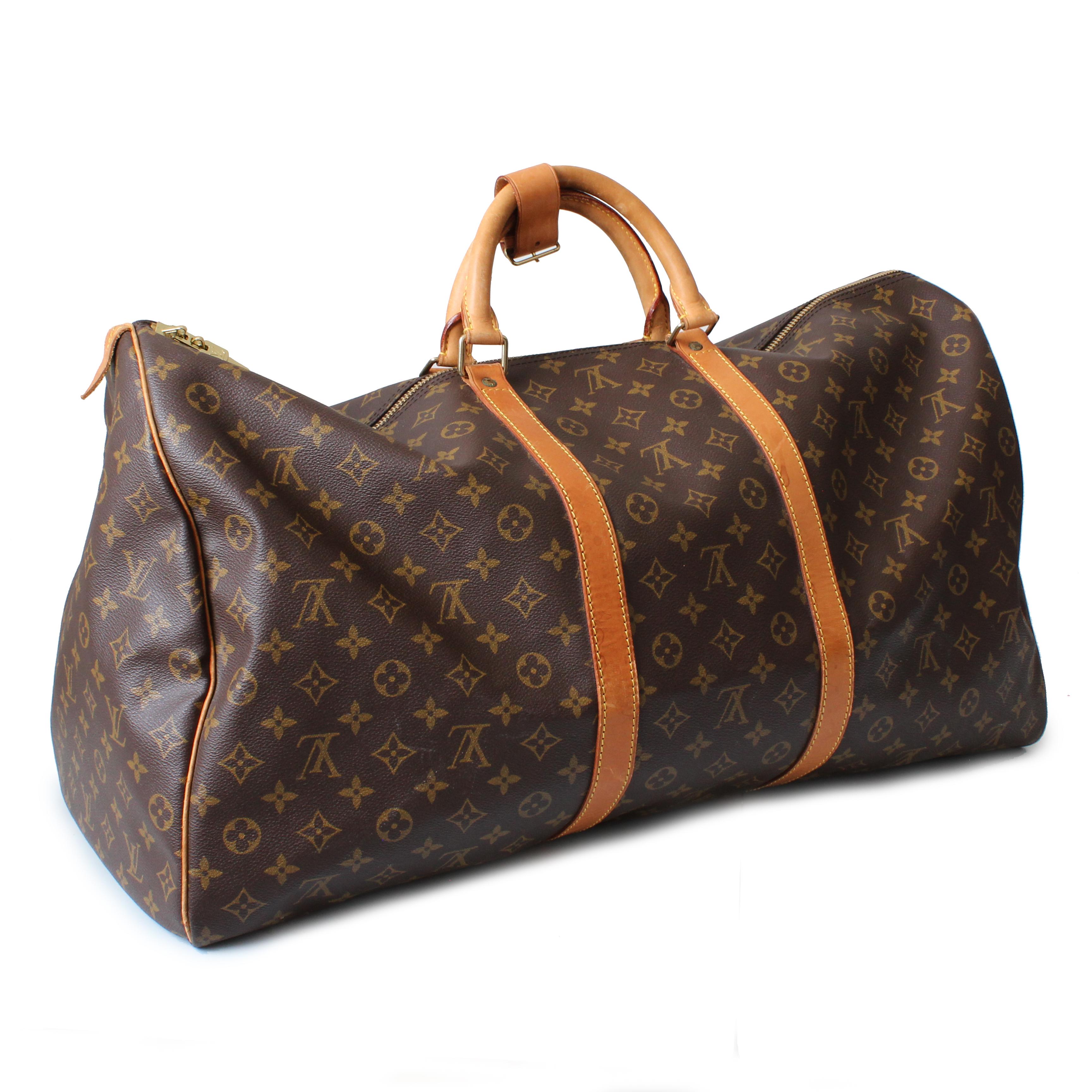 Authentic, preowned, vintage Louis Vuitton Keepall 60 Duffel Bag in Monogram Canvas, made in 1993.  Comes with handle keeper & luggage tag. Lined in canvas, double zipper closure.  Large bag that holds a TON! Measures appx 24in L x 13in H x 10in D