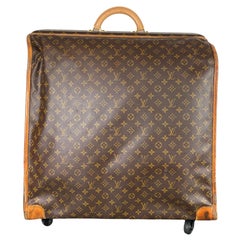 LOUIS VUITTON VINTAGE GARMENT BAG, monogrammed with top handle,  manufactured by The French Co, USA, under special licence, main pocket  inside plus externalo side pockets, hanging hook, 54cm x 20cm closed x